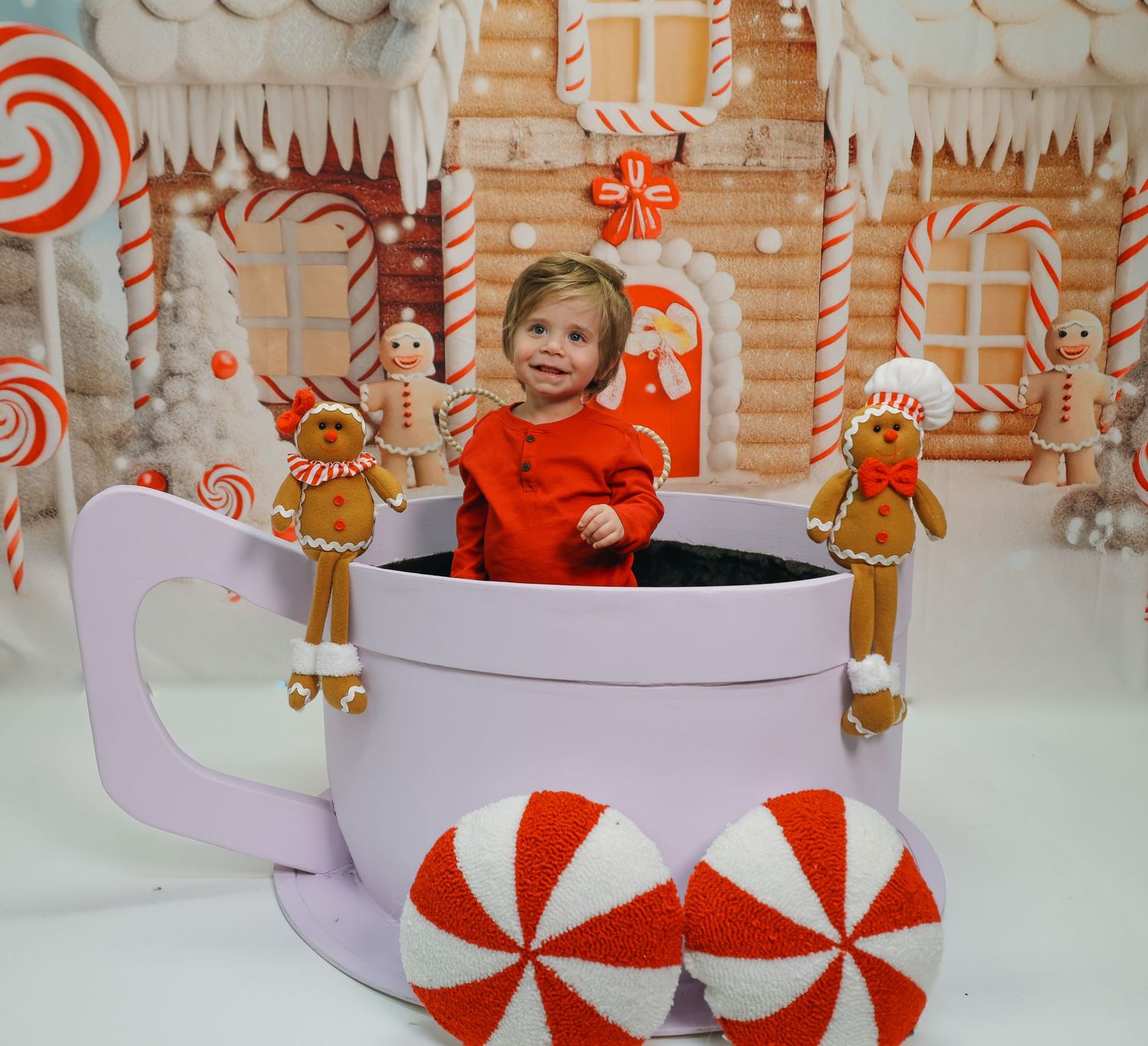 A series of decorative red and white peppermint-themed Christmas ornaments and holiday decor arranged in a festive display.