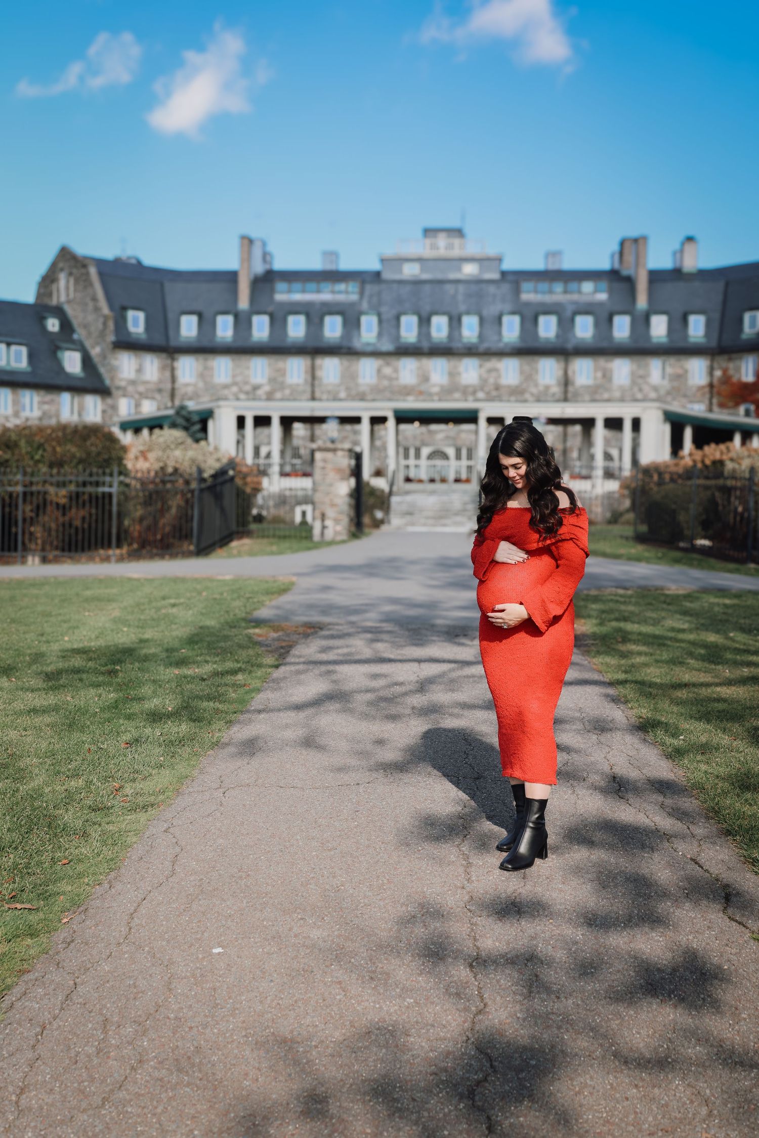 A sequence of photos showing a person in a bright red coat walking along a path towards a grand historic stone building.