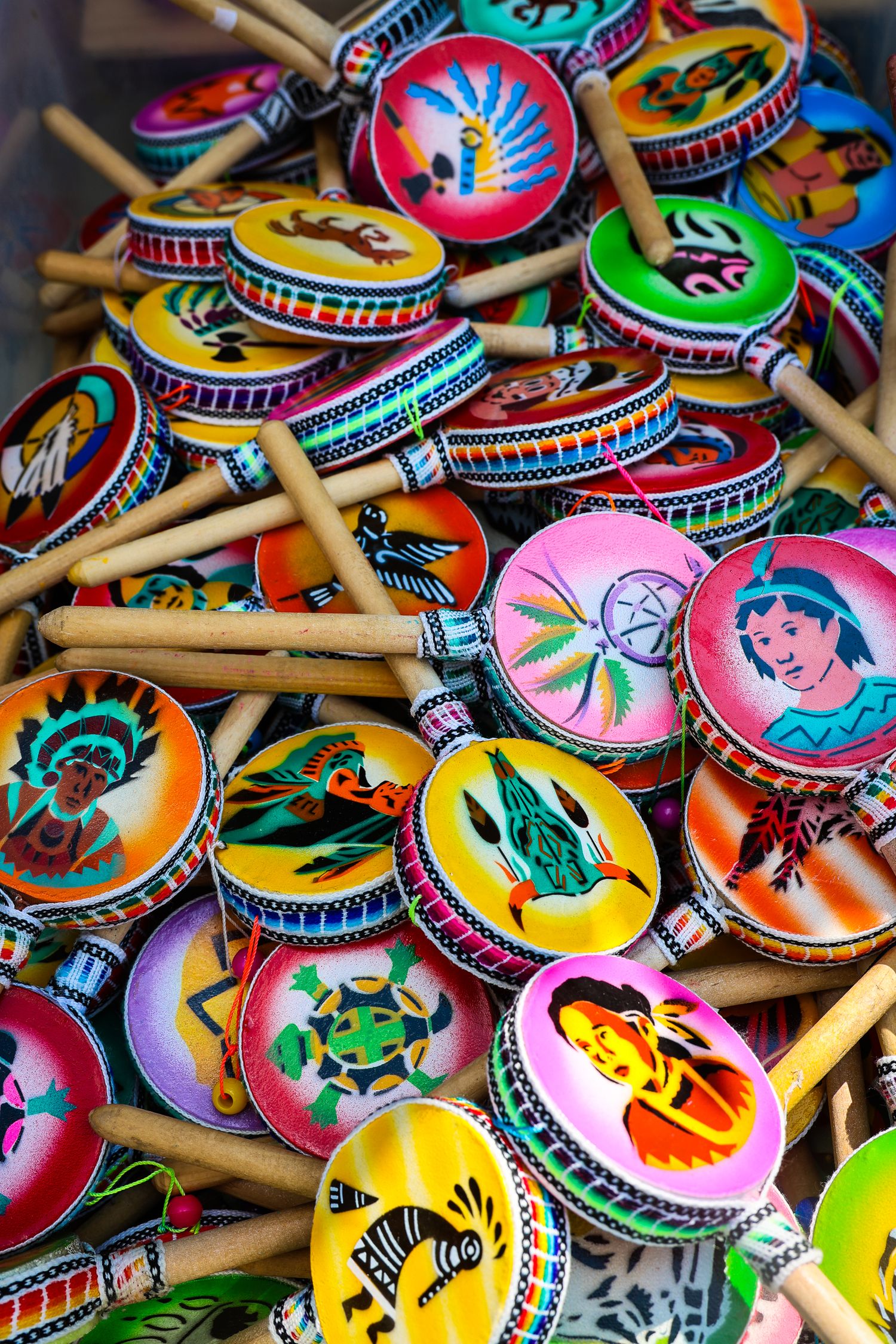 Colorful collection of Mexican maracas with vibrant painted designs featuring traditional folk art patterns and decorations.
