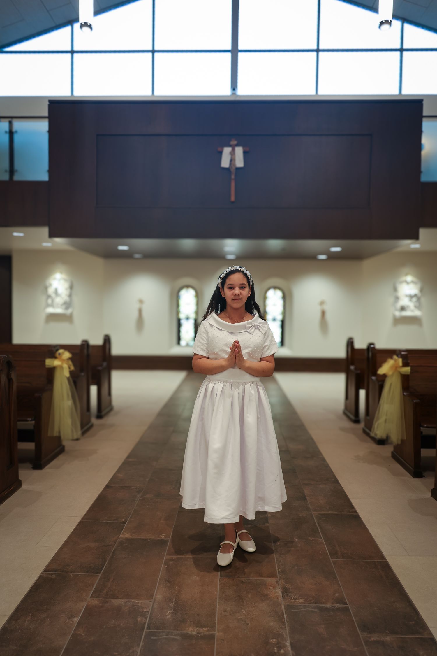 A sequence of images showing a person in a white dress walking down the center aisle of a church sanctuary.