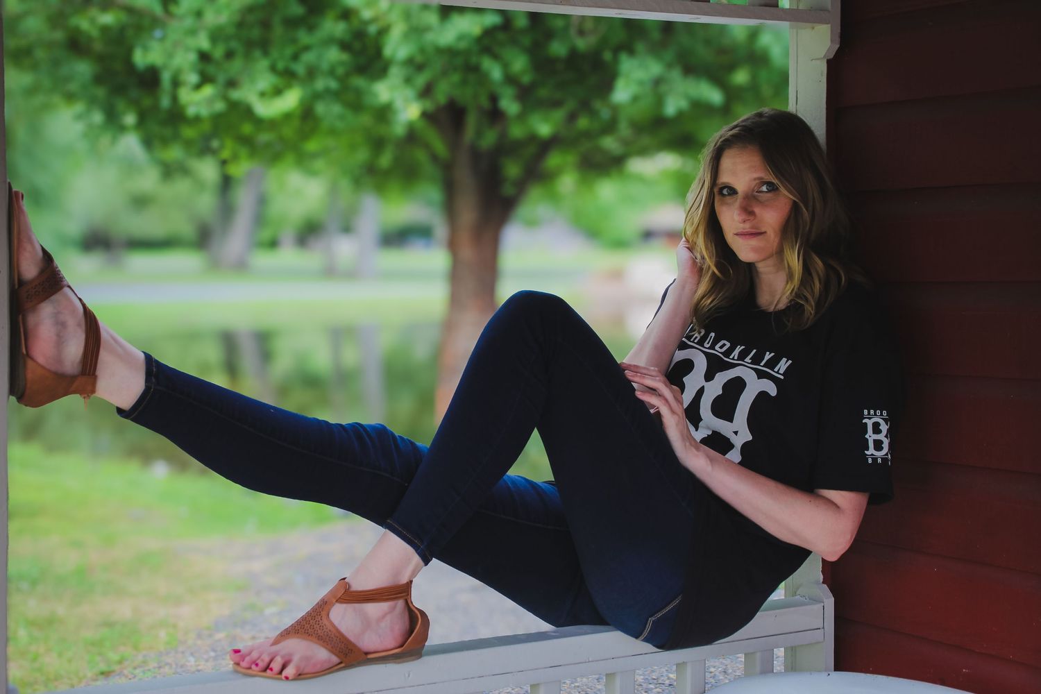 A series of yoga poses demonstrated on a wooden deck surrounded by lush green foliage in an outdoor setting.