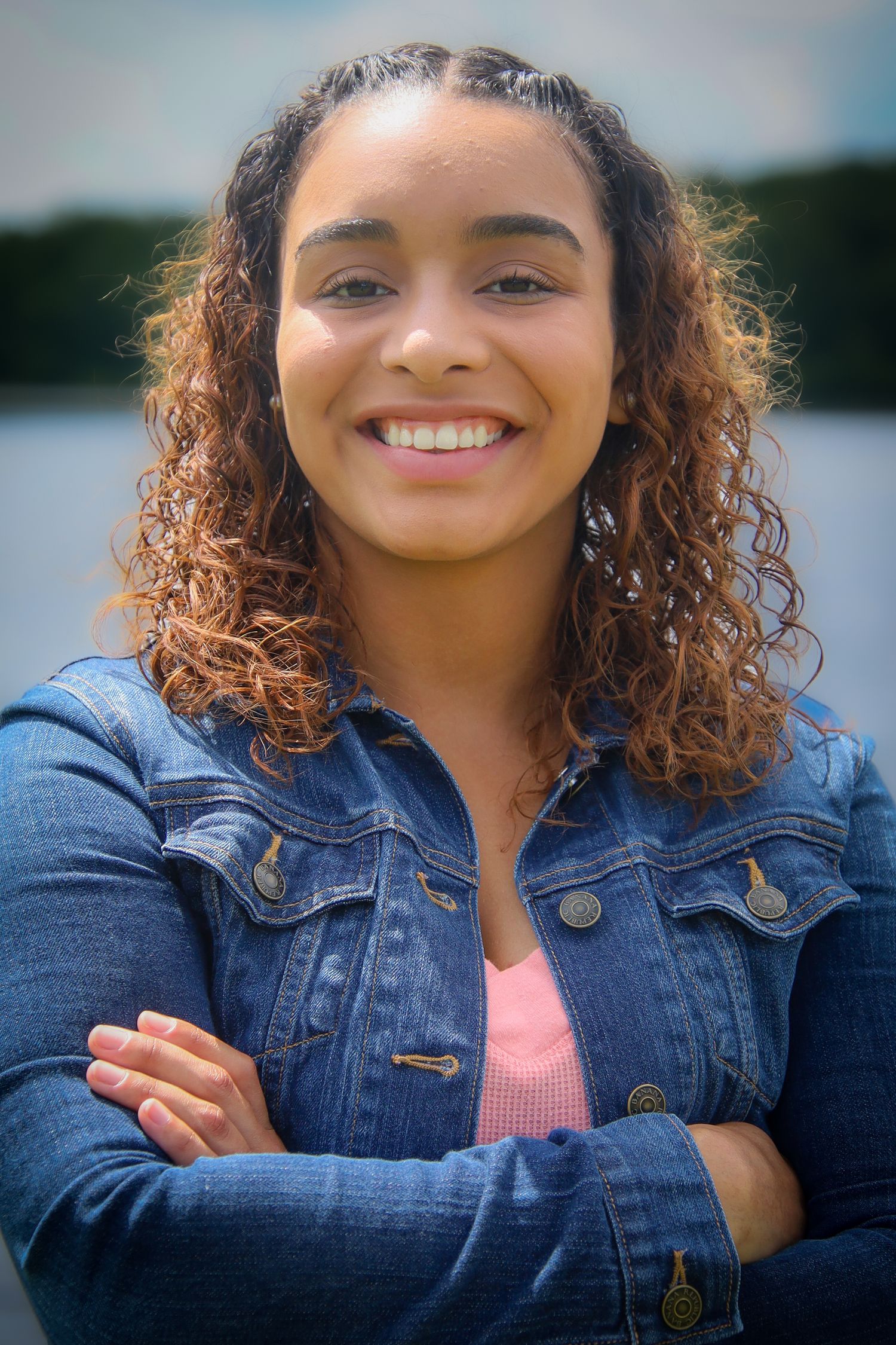 A series of outdoor portrait shots showing someone wearing a denim jacket and pink top against a waterfront background.