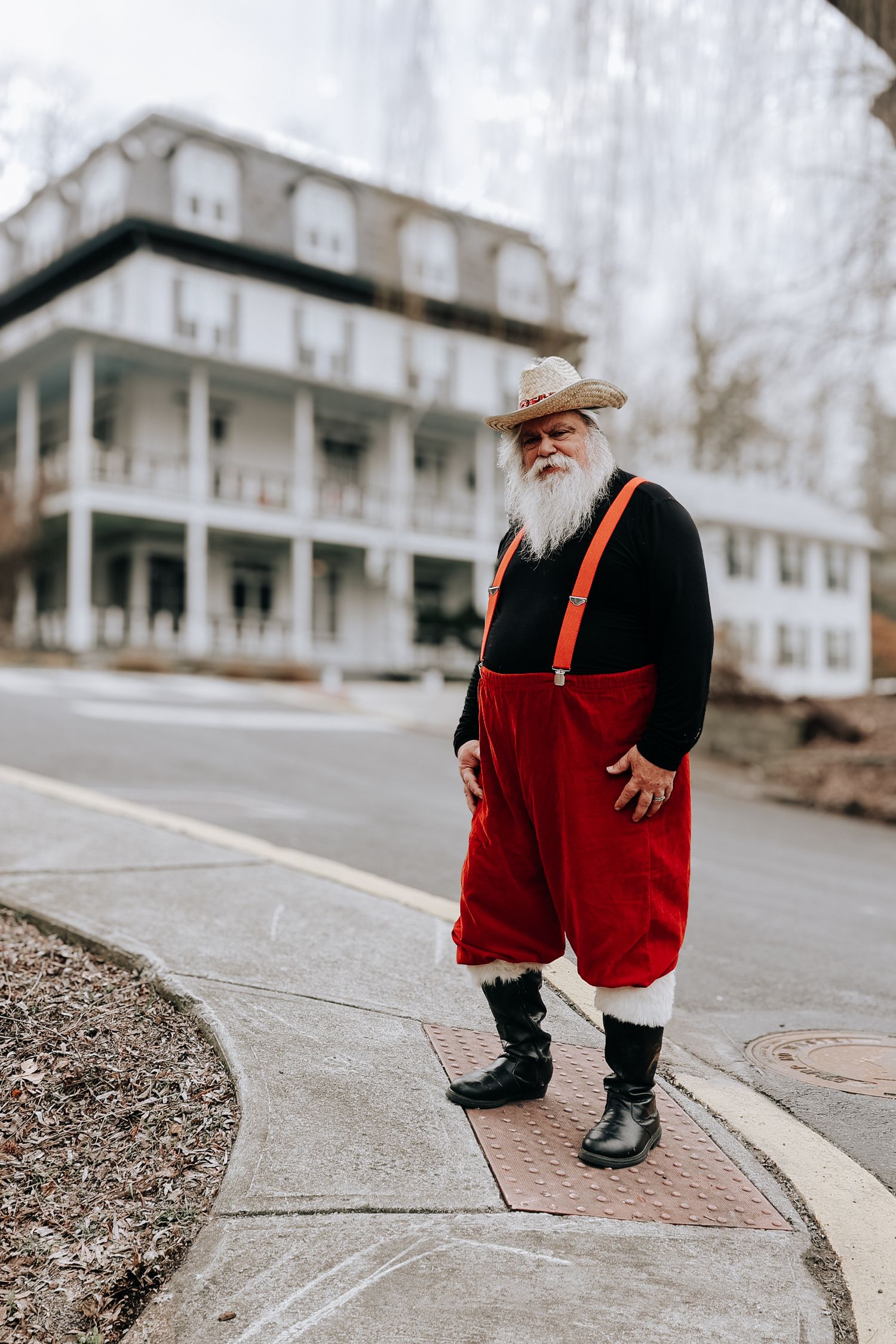 A series of photos showing someone in festive red and black attire walking along a sidewalk near a white building.