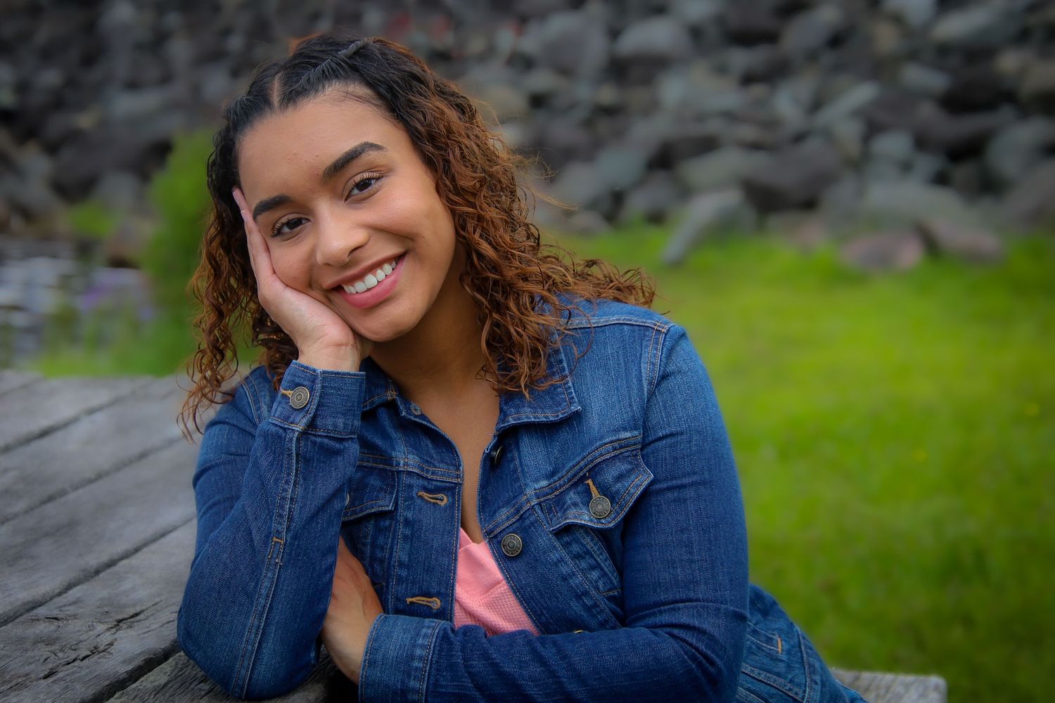 A series of casual outdoor portrait photos featuring someone in a denim jacket against a rocky and grassy background.