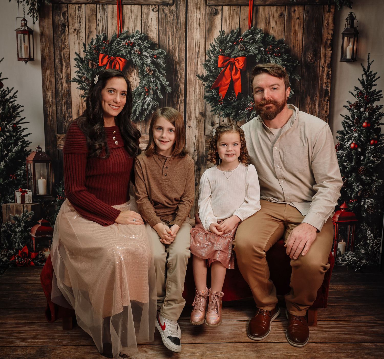A series of festive holiday family portraits in front of a Christmas tree with matching burgundy and brown outfits.