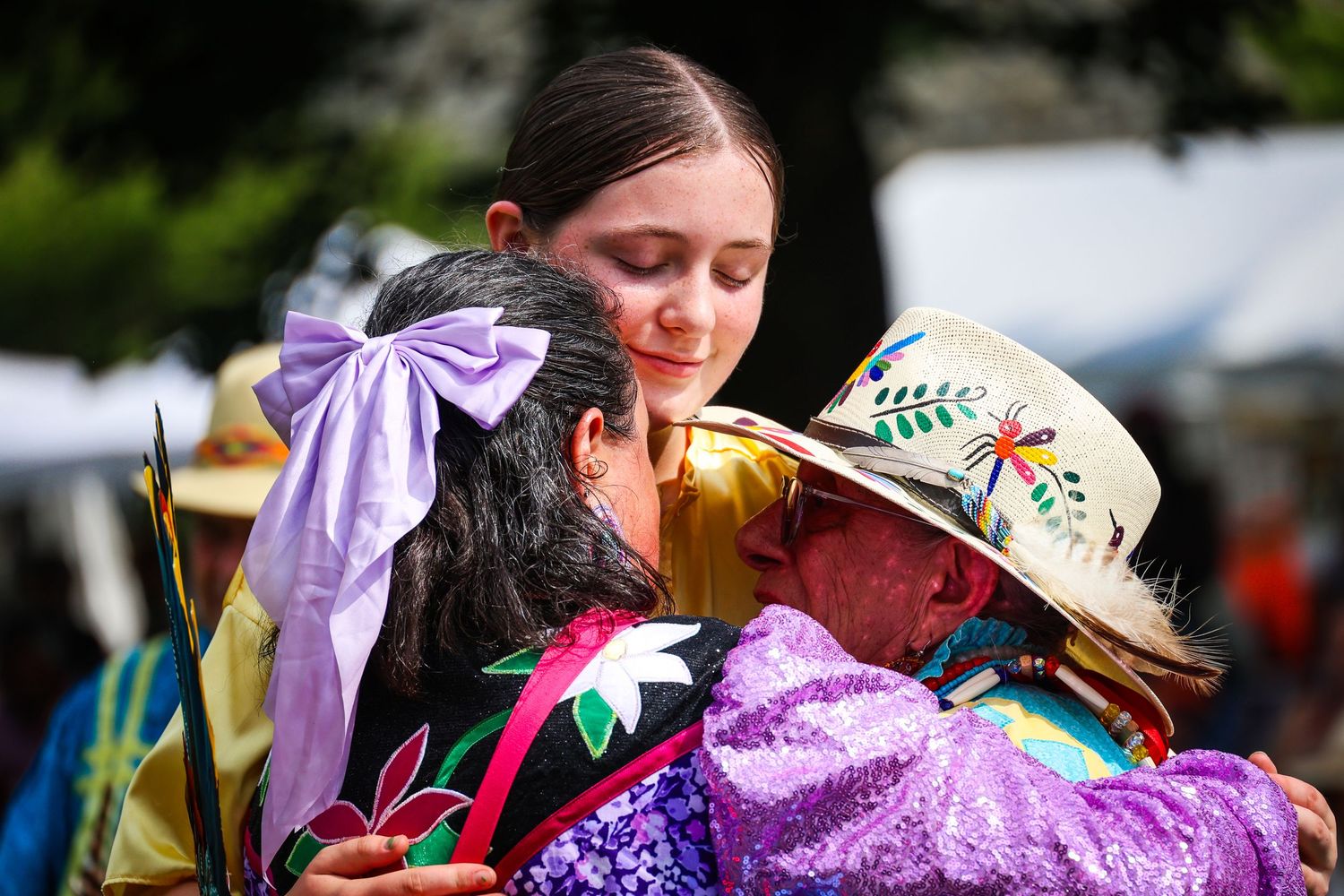 Dancers in colorful traditional Mexican folk costumes perform at an outdoor cultural festival.