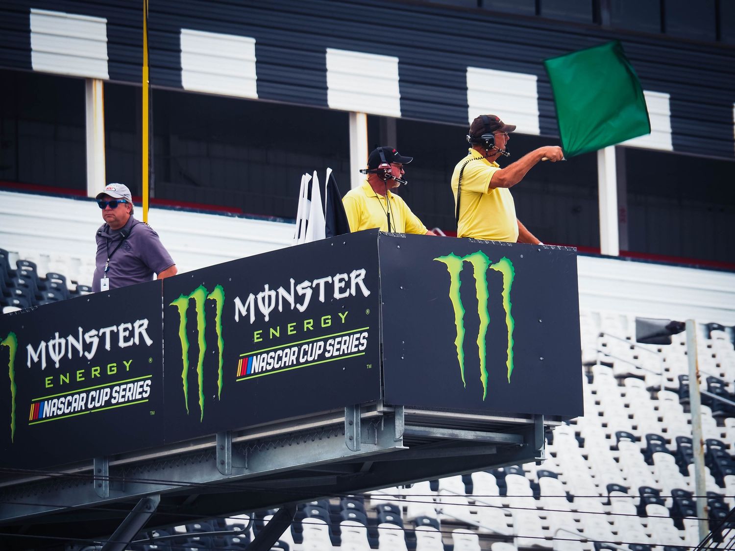 Monster Energy branding and logos displayed on black signage at a sporting event venue.