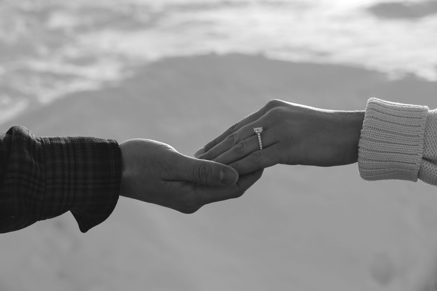 Black and white sequence of hands passing a piece of paper from left to right showing a chain of delivery.