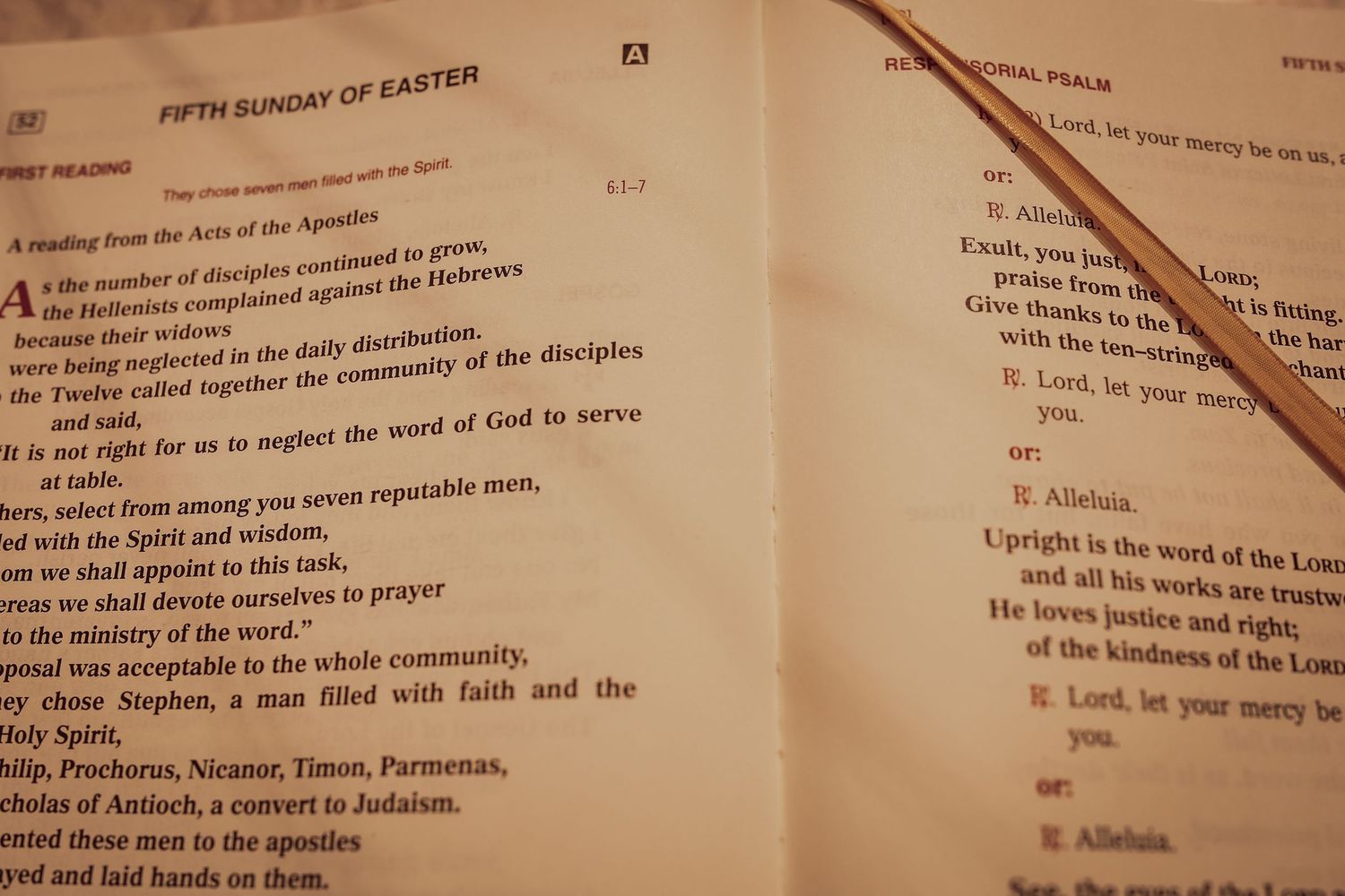 Open Bible pages showing text from a Christian liturgical book with sections marked for Easter readings.