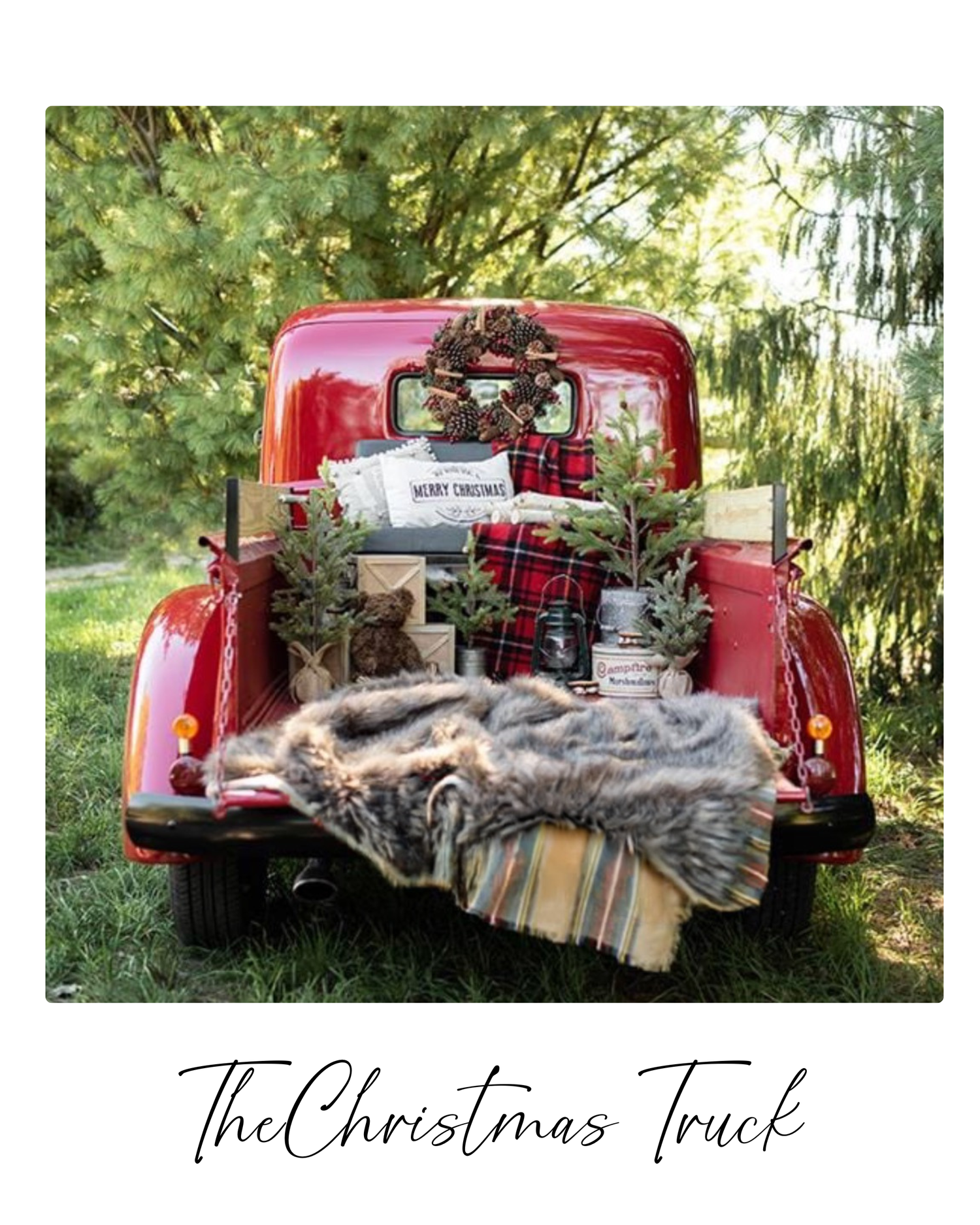 A vintage red pickup truck decorated with cozy plaid blankets and rustic decor for Christmas photography.