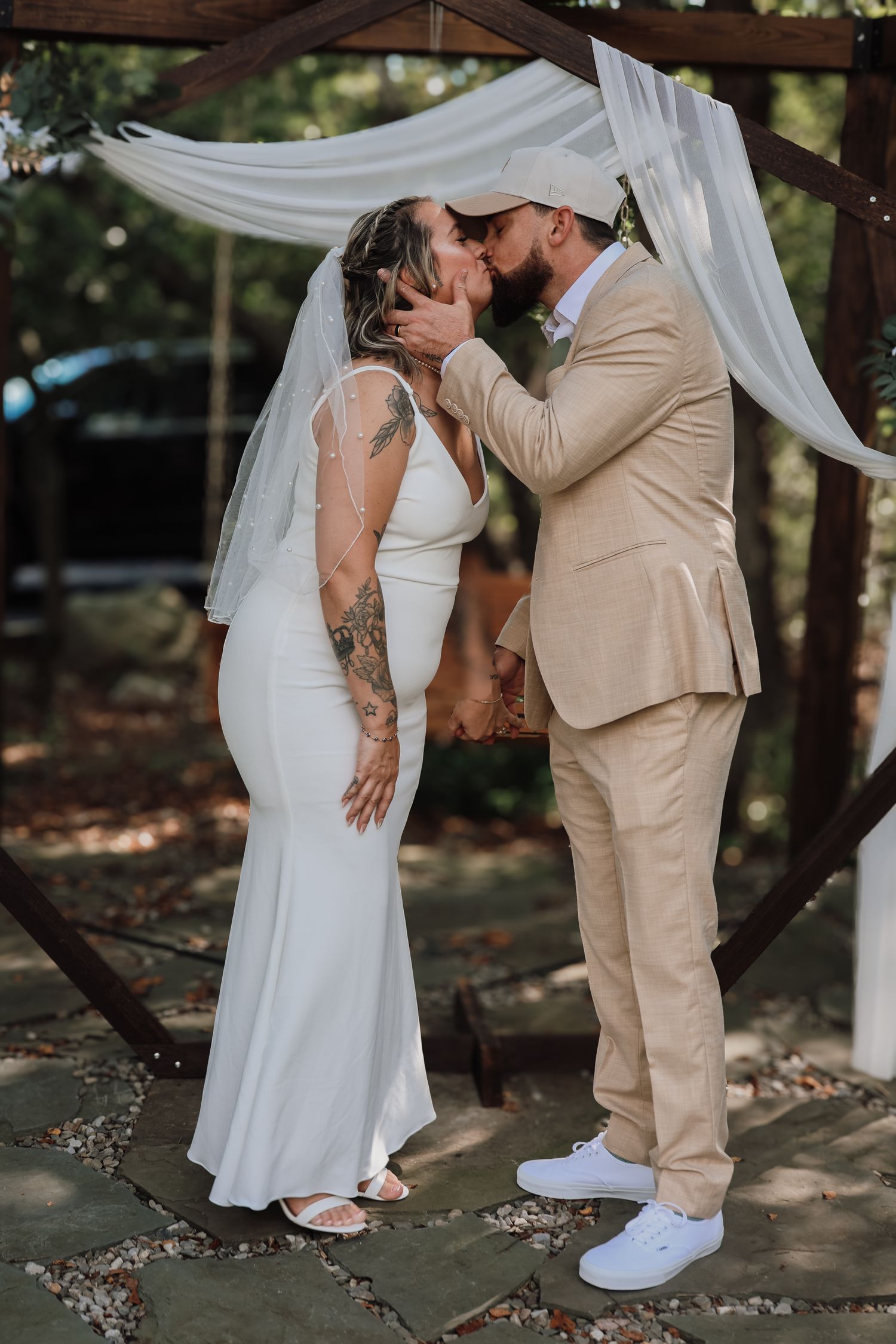 A romantic wedding moment captured in a series of photos showing a couple in white and beige beneath flowing white drapes outdoors.