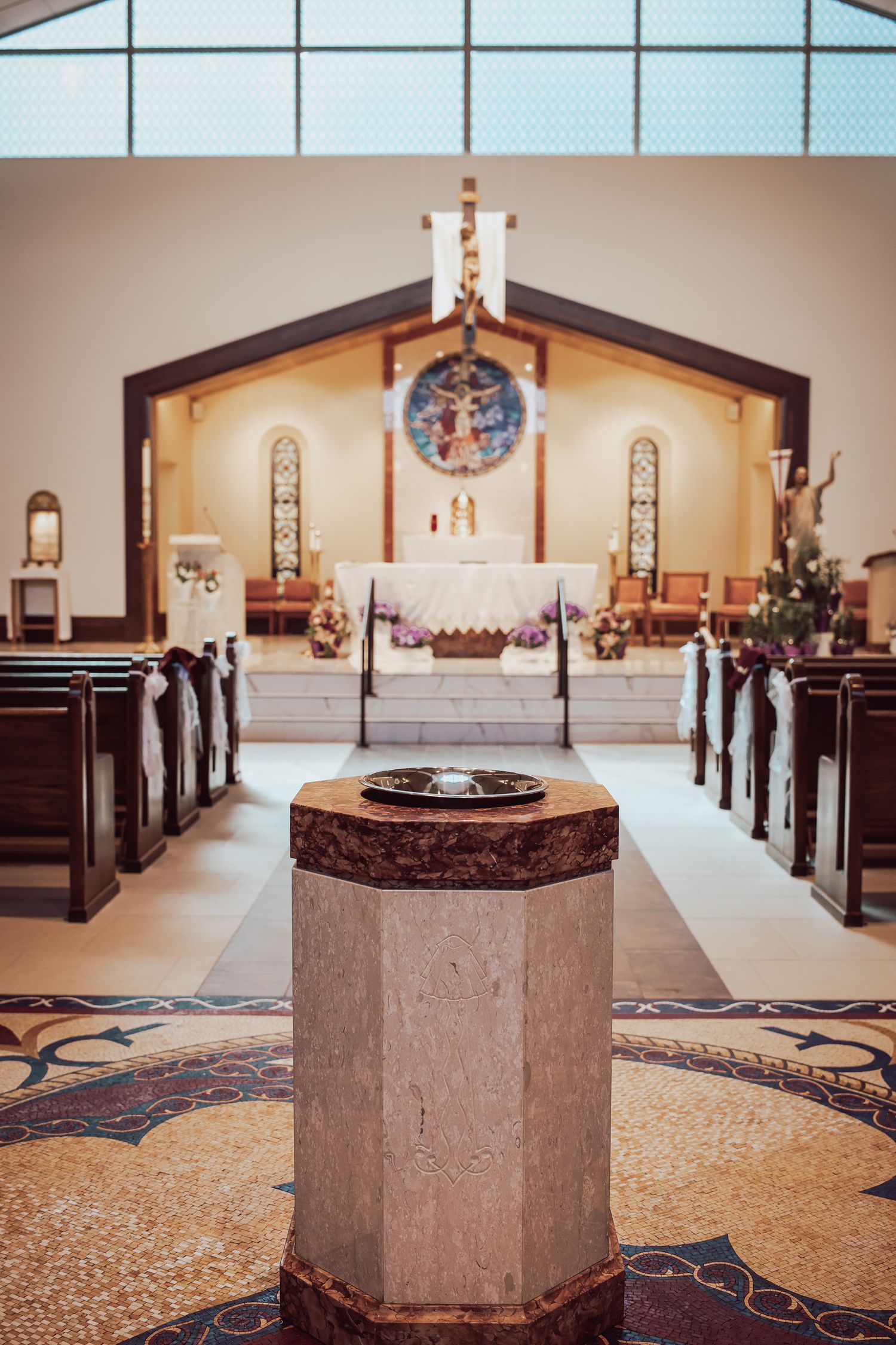 A series of interior church photos showing the altar and baptismal font from different angles in a modern sanctuary.