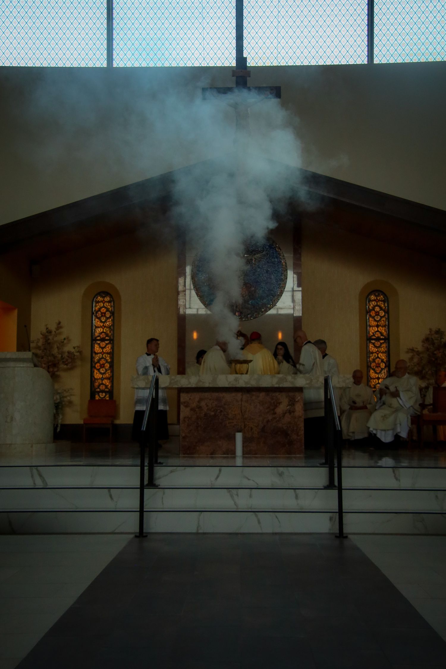 A sequence of images showing smoke effects and special lighting during a stage performance.