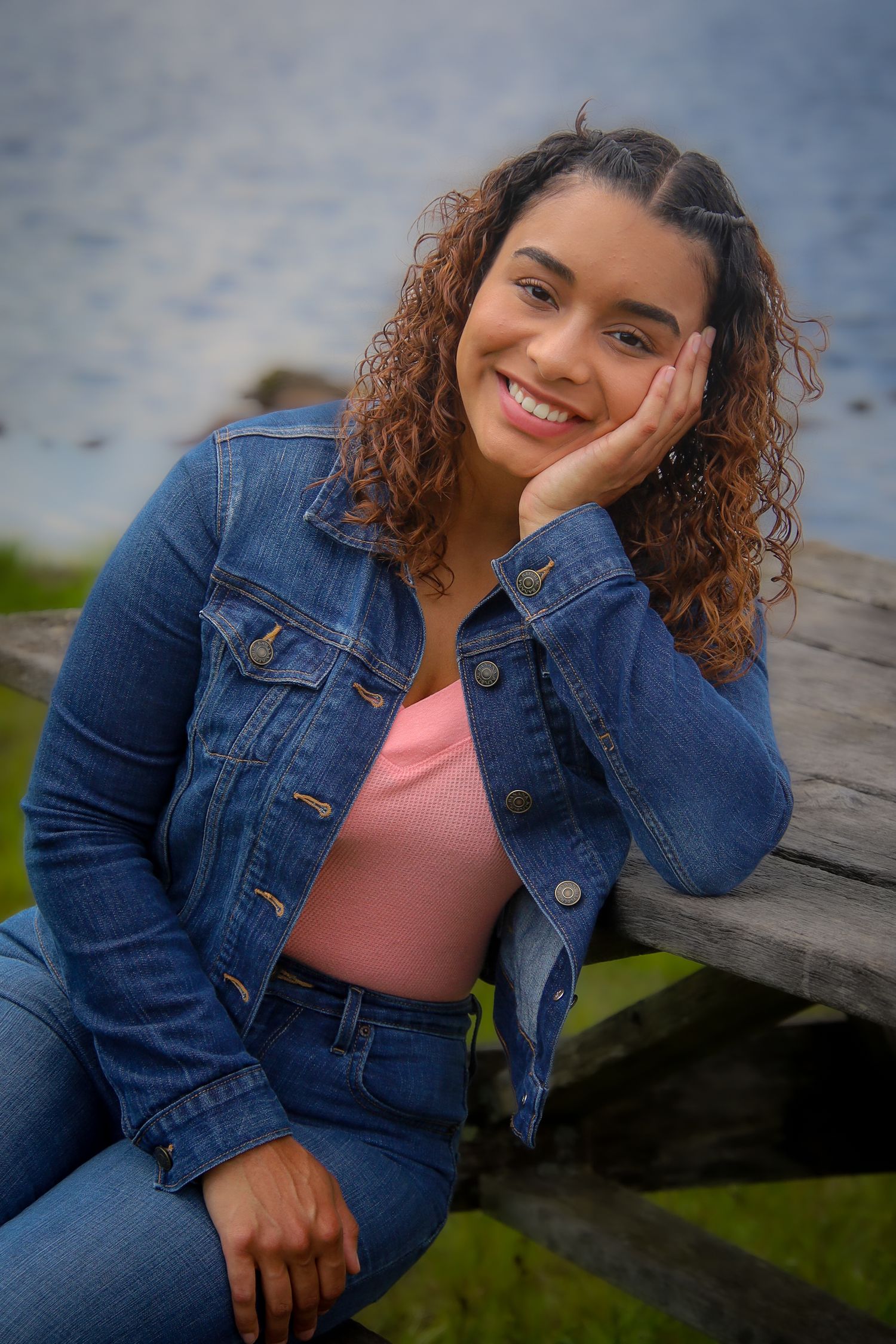 A series of casual outdoor portraits featuring someone in a denim jacket and pink top posing near water.