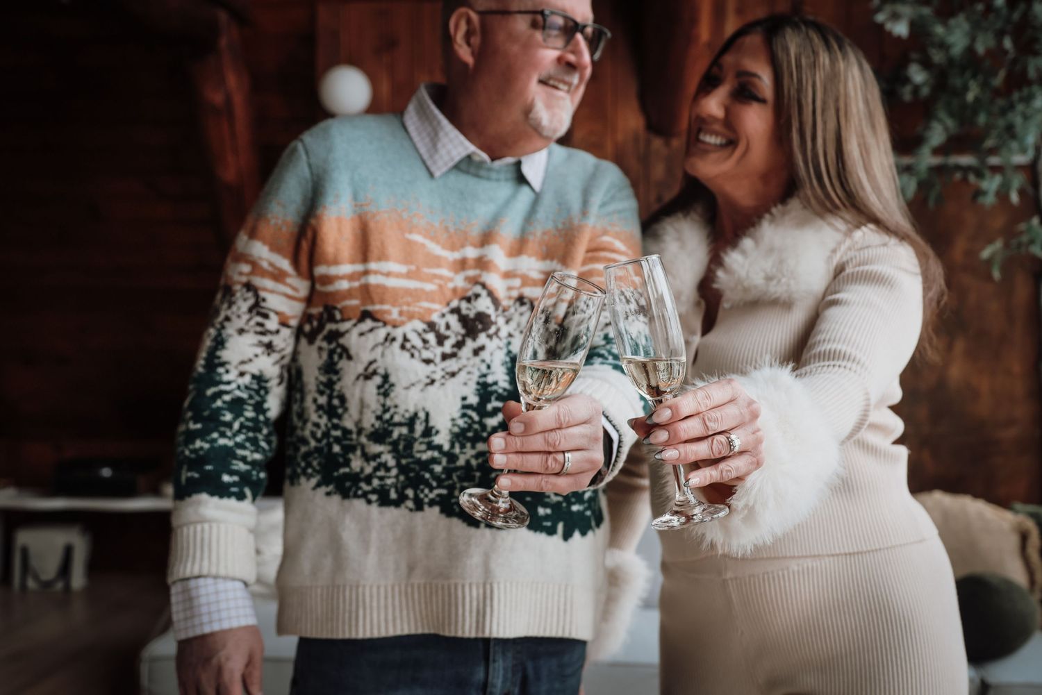 A couple wearing cozy sweaters share intimate moments together in a warm indoor setting during winter.