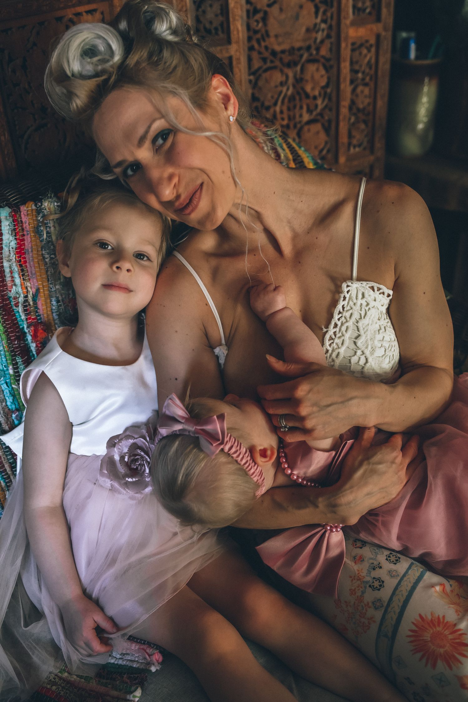 A series of intimate family moments captured in warm tones showing tender interaction between parent and child on a patterned sofa.