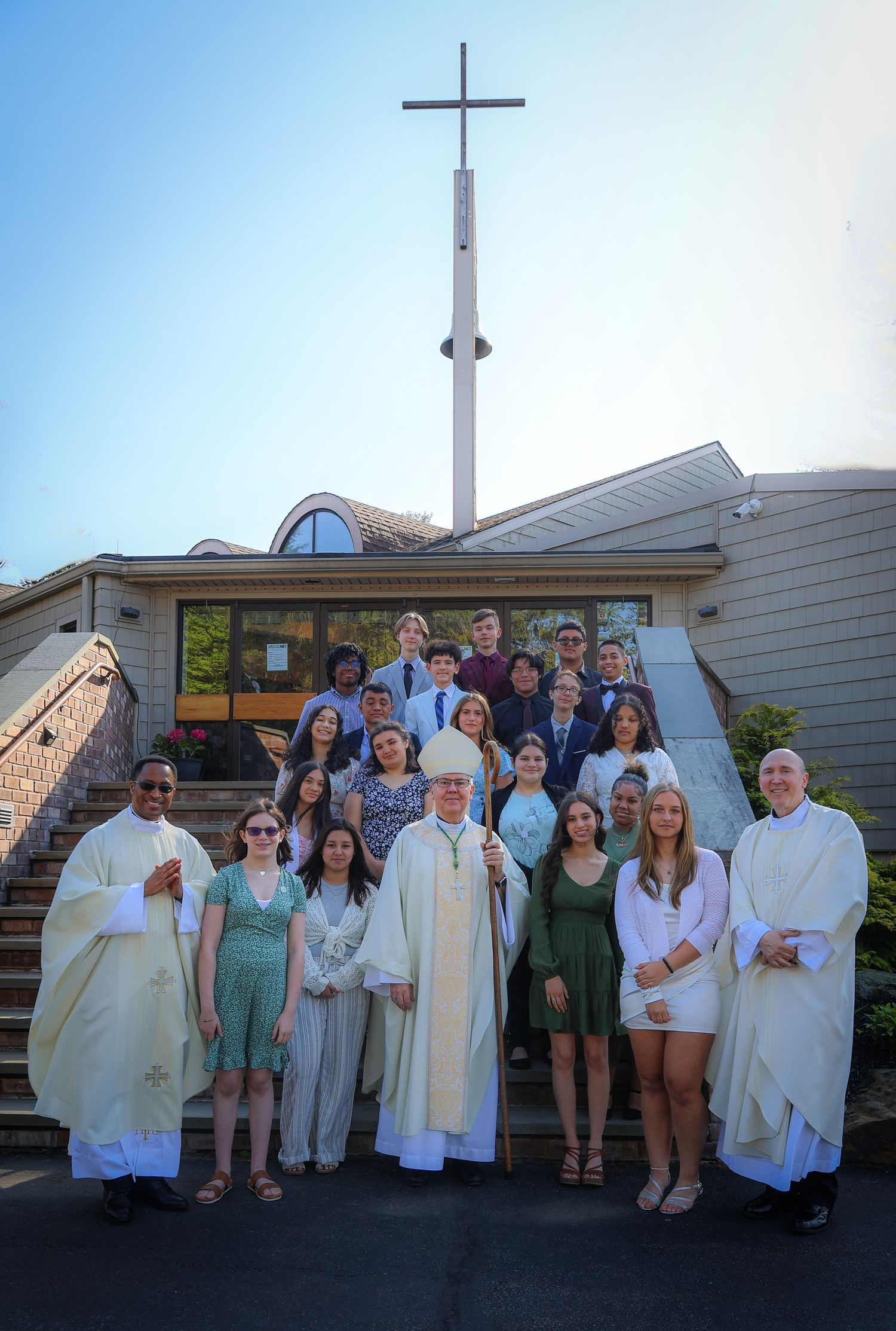 A series of group photos taken outside a church building with crosses visible on the rooftop.