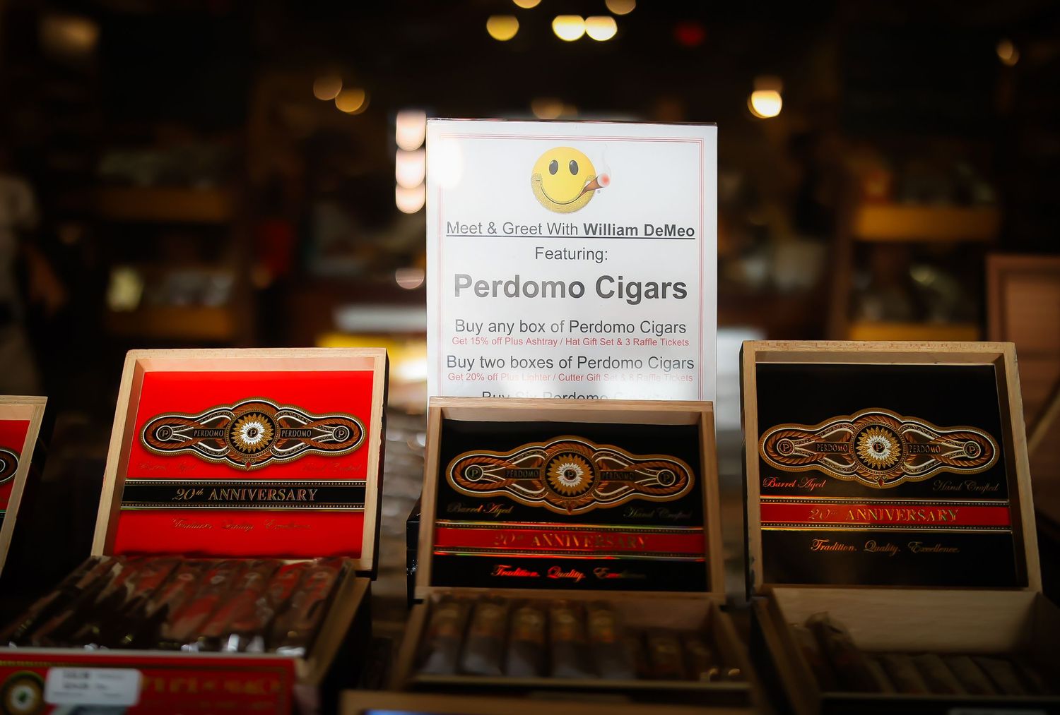 Close-up view of retail shelf displays showing various cigar boxes and product cards in a dimly lit setting.