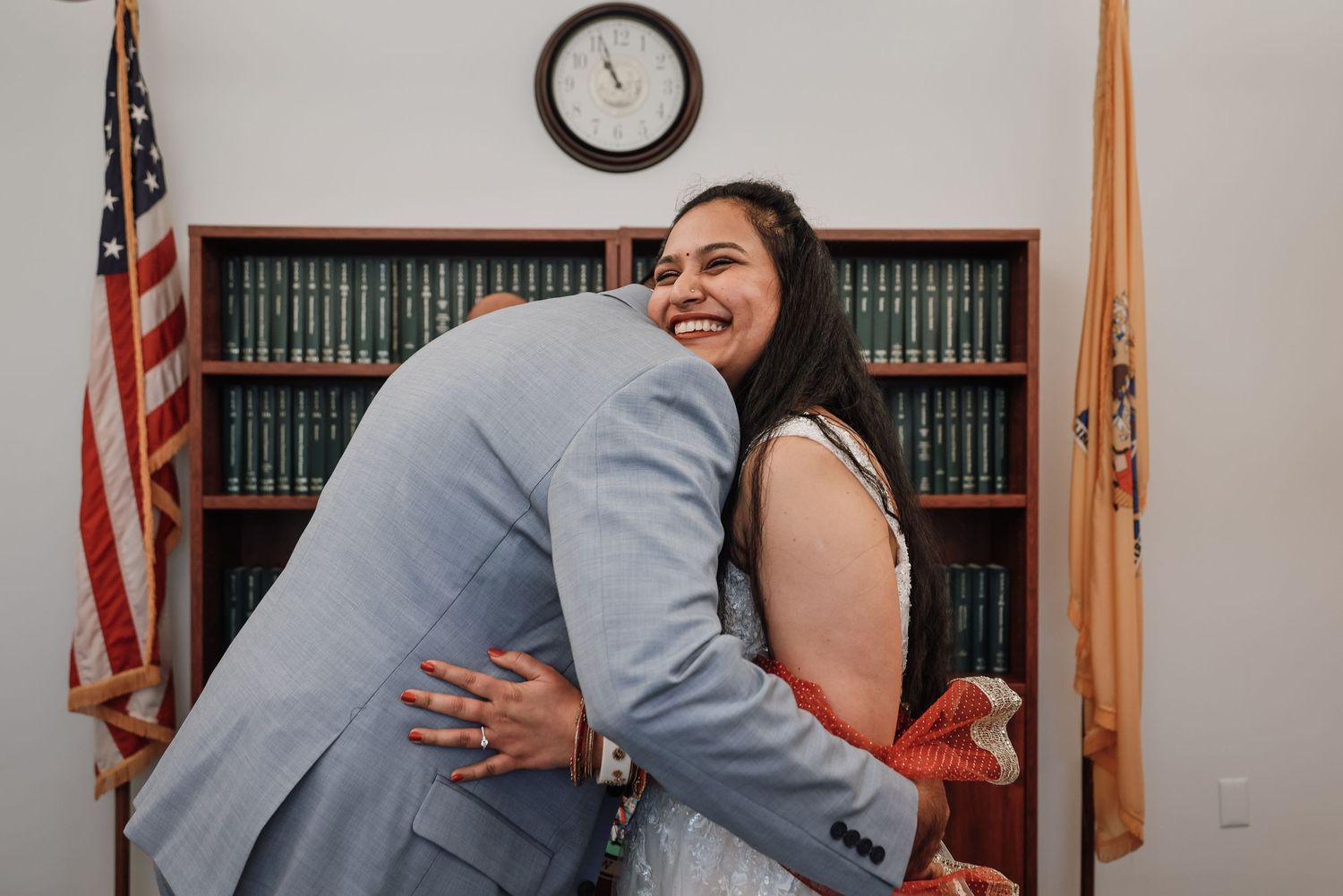 A joyful scene in a courthouse with a couple embracing and celebrating after their wedding ceremony.