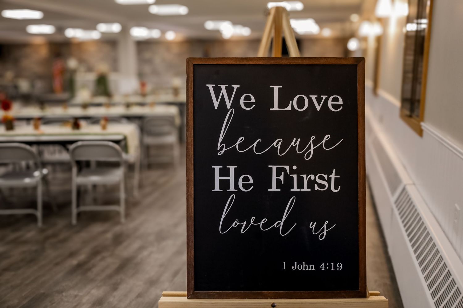 A collection of black and white signs with inspirational quotes and Bible verses displayed on wooden walls.