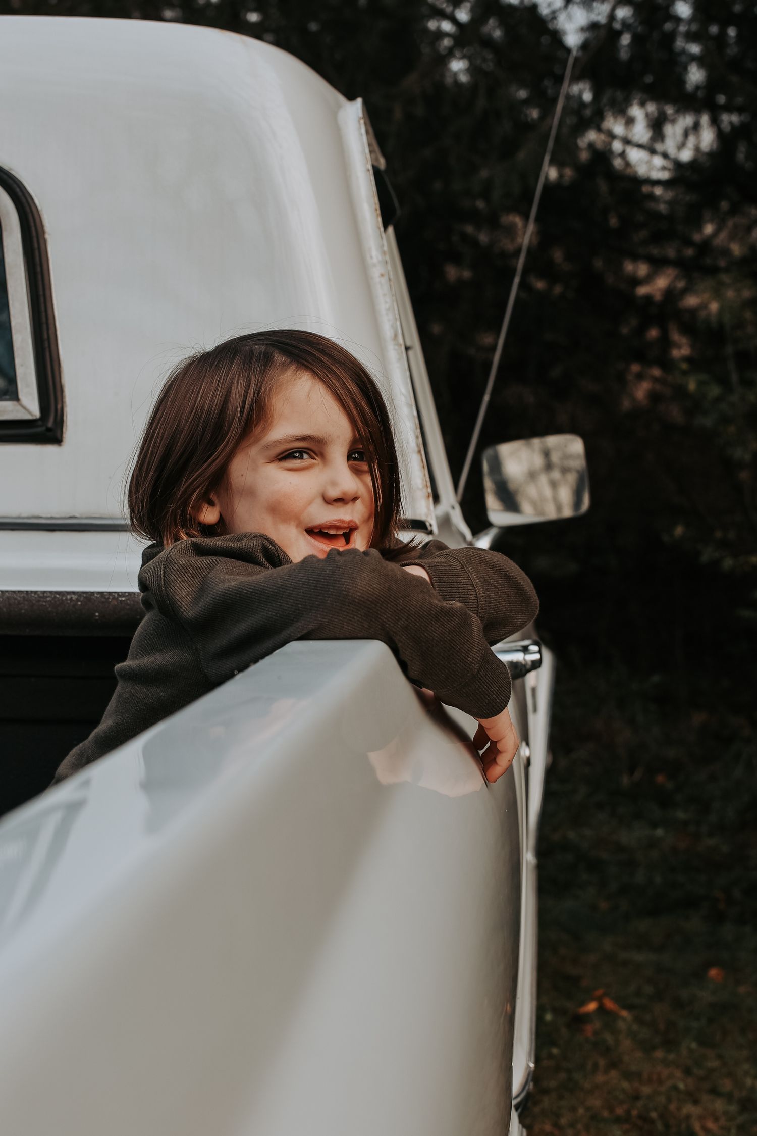 A sequence of moody photos shows someone peeking through a car window from different angles.