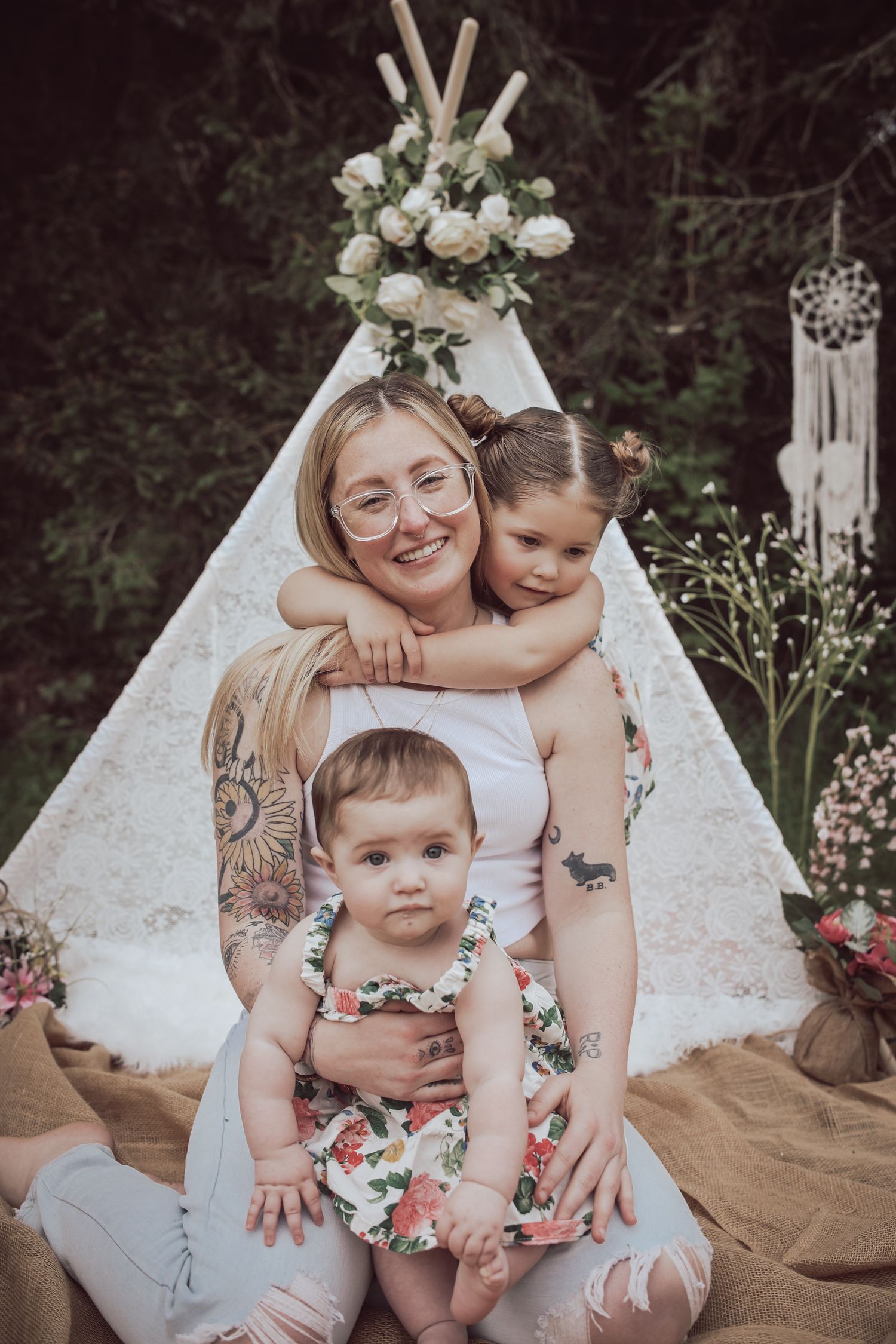 A series of intimate family portraits showing tender moments between mother and children against a white teepee backdrop.