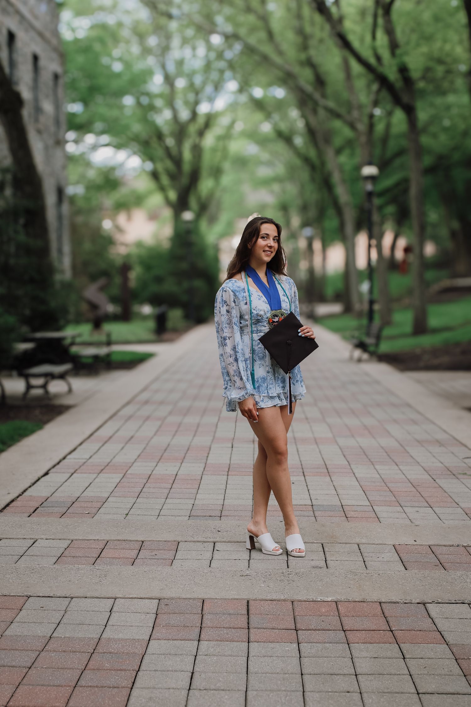 A series of photos showing someone in a blue plaid shirt and white sneakers posing on a tree-lined brick pathway.