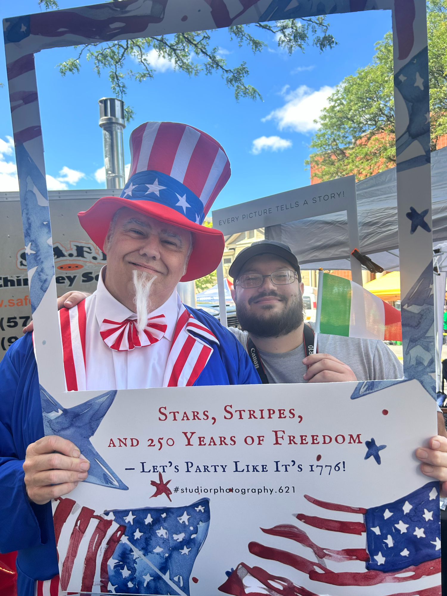 People holding open history books and wearing patriotic American attire celebrating the 250th anniversary of independence.