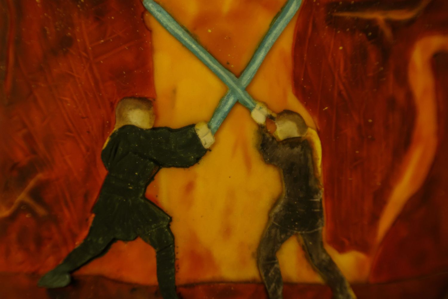 A silhouetted figure performs a dynamic breakdancing move against a vibrant orange and red background.