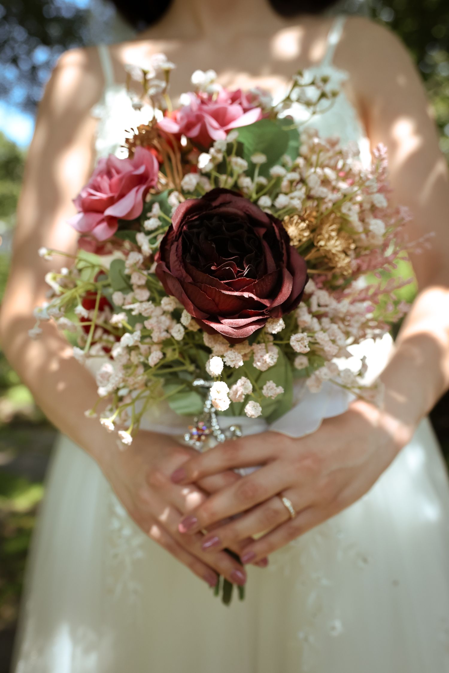 A series of wedding bouquet closeups showing pink roses and baby's breath flowers held by hands in a white dress.