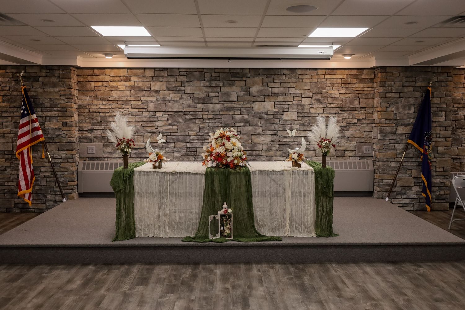 A panoramic view of green nutcrackers displayed against a stone wall backdrop in a gallery-like setting.