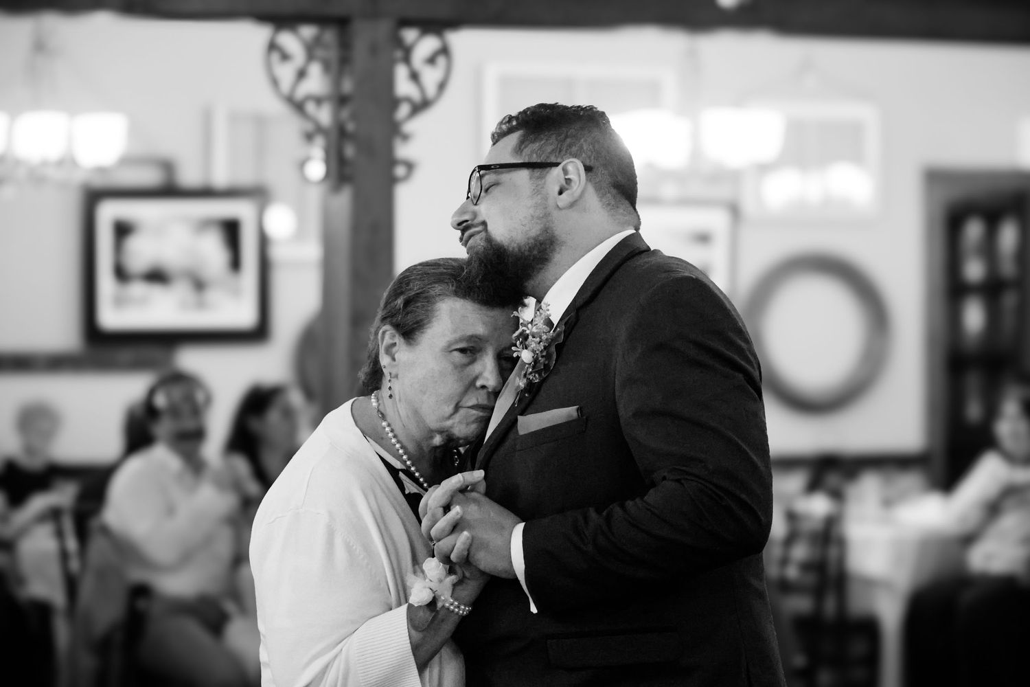 A couple shares a romantic dance together at an indoor reception venue.