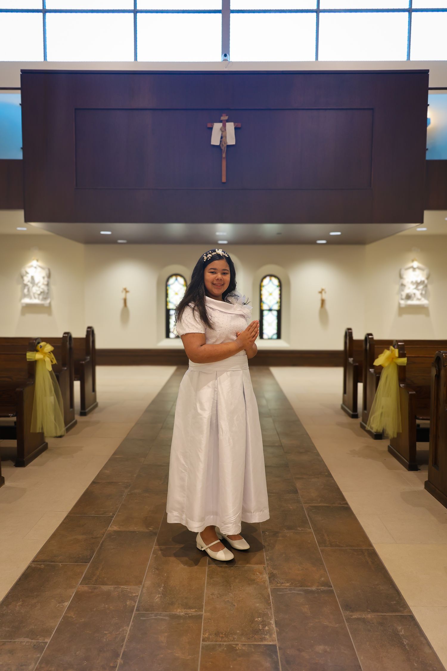 A sequence of photos showing someone in a white dress walking down a church aisle with stone flooring.