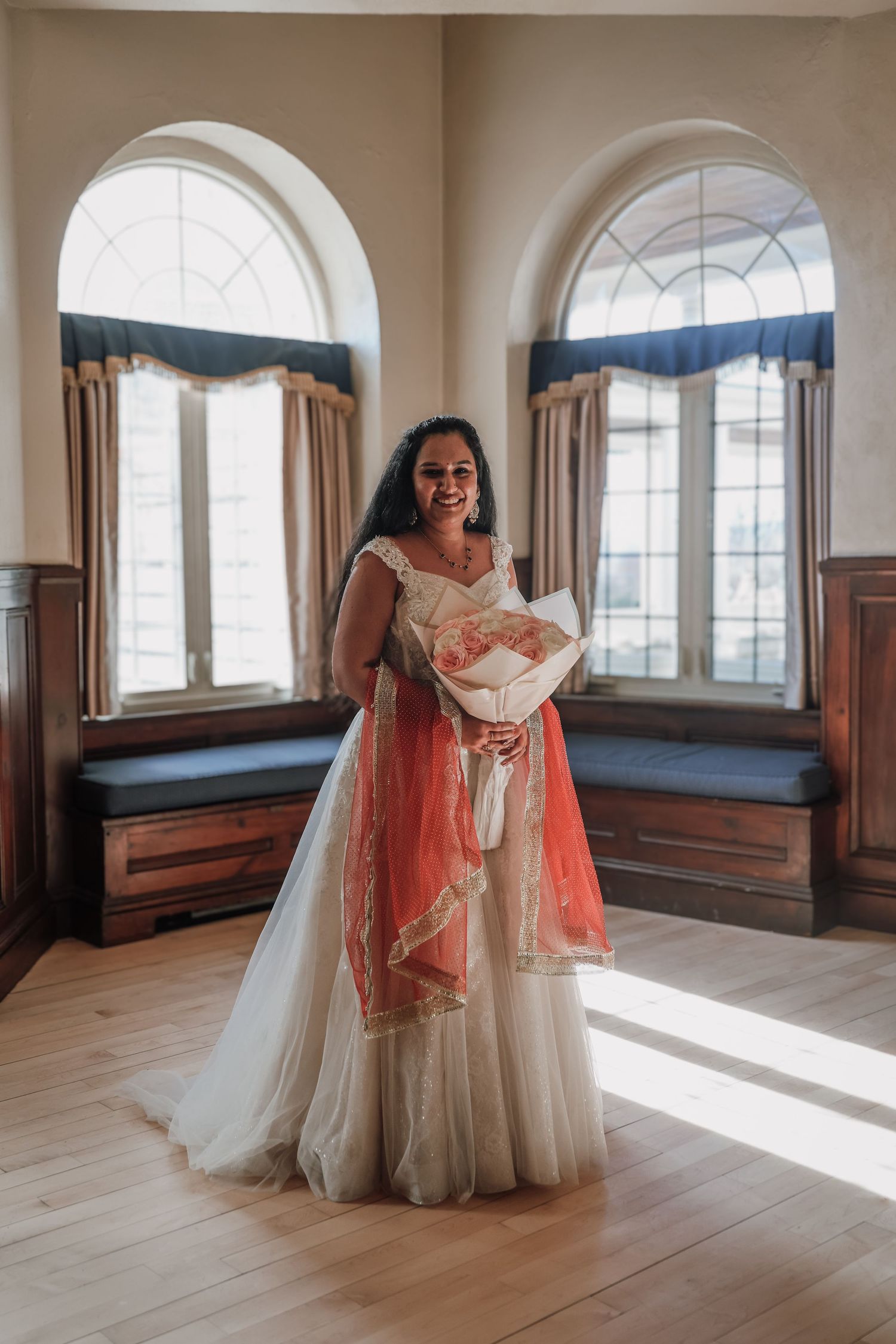 A series of five wedding dress photos showing a bride in a traditional gown and coral dupatta in a sunlit room with arched windows.