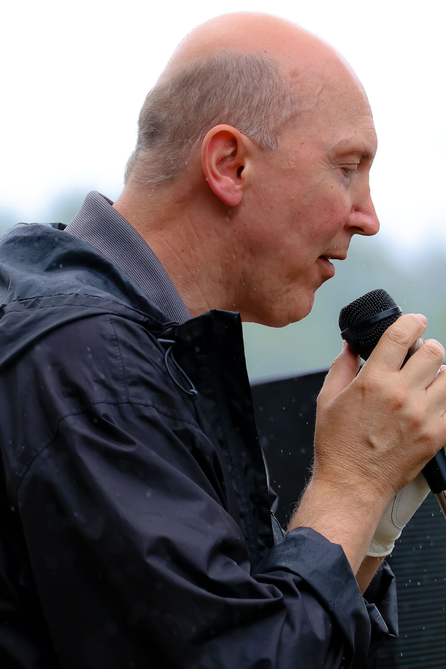 A sequence of profile shots showing a person in a dark jacket looking through a camera lens.