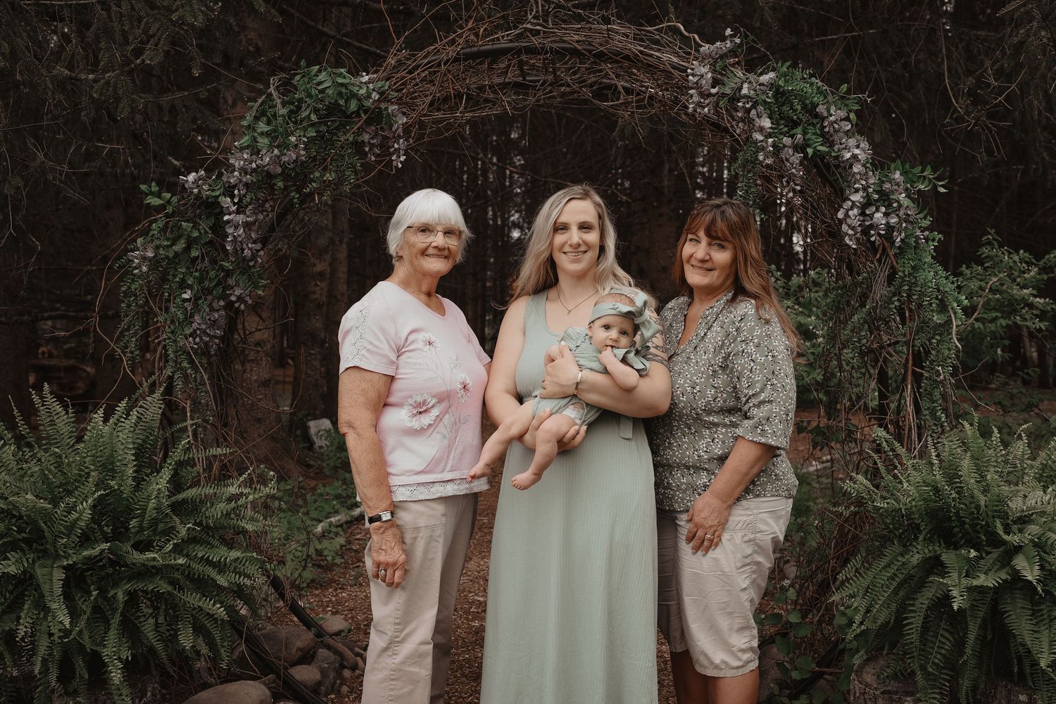 A group stands together in a garden setting wearing coordinated mint green and white outfits for a special occasion.