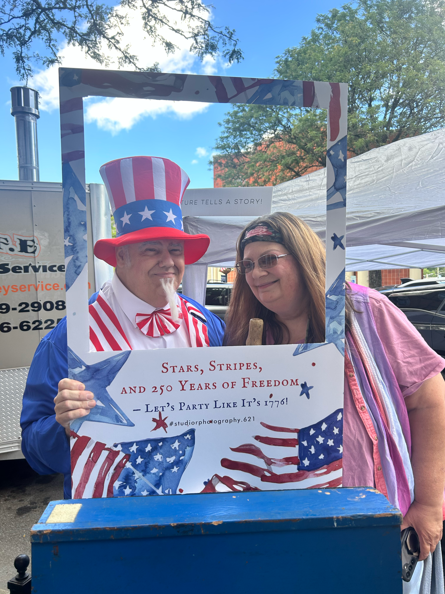 A collection of patriotic July 4th Independence Day decorations and signs featuring red white and blue American themes.
