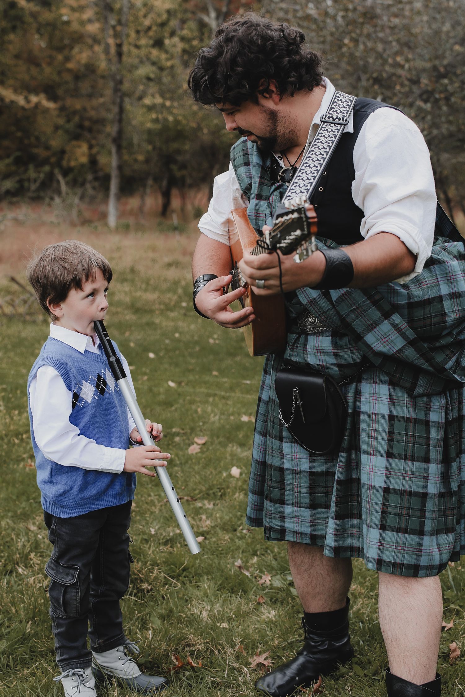 A series of candid moments showing someone in traditional Scottish kilt teaching a young child to play the bagpipes outdoors.