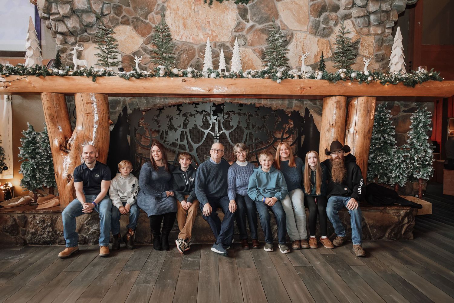 Guests mingle and socialize at a rustic indoor venue with stone walls and wooden beams.