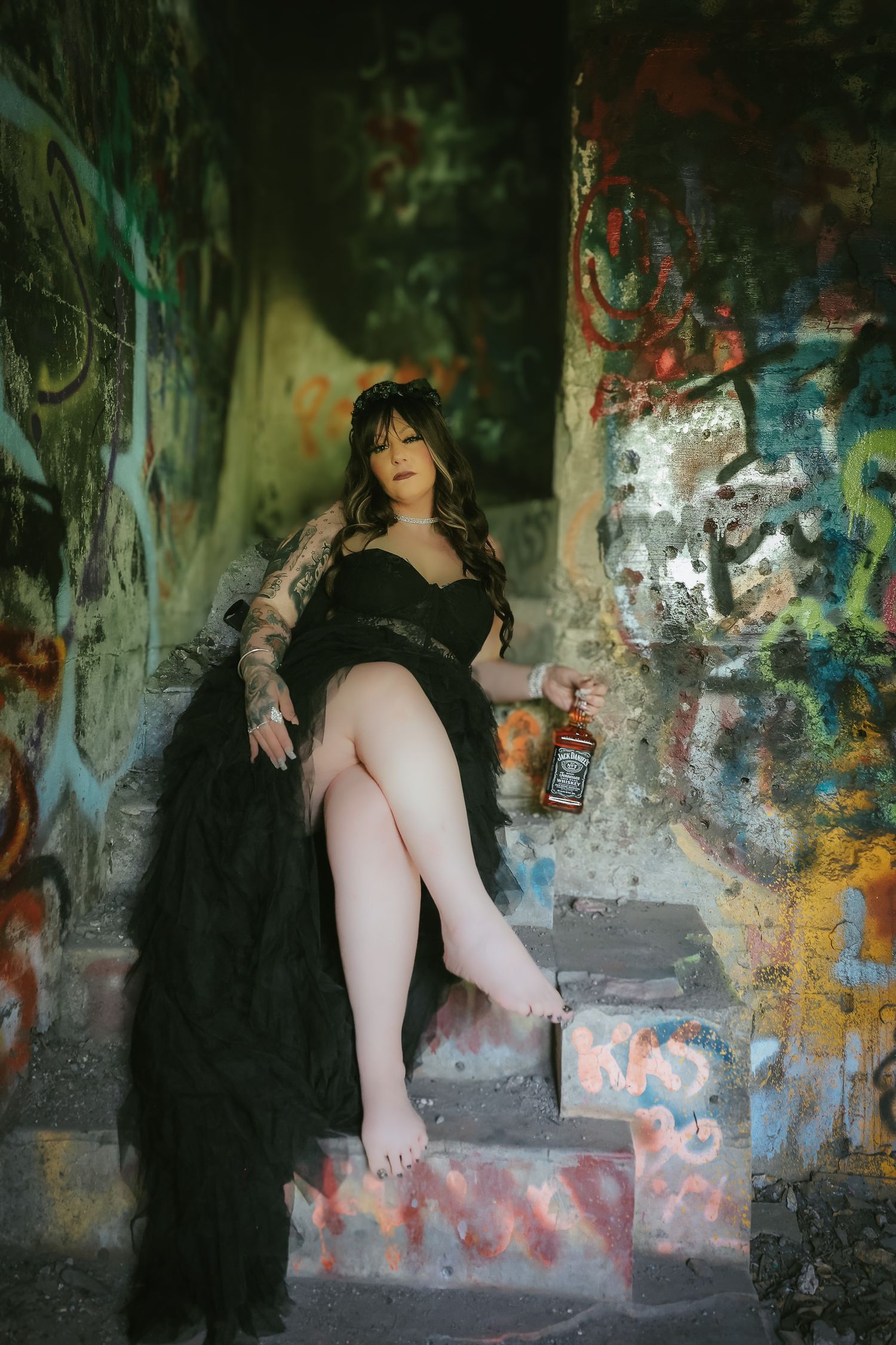 A dark artistic photo sequence showing a figure in black against a graffiti-covered wall in an urban setting.