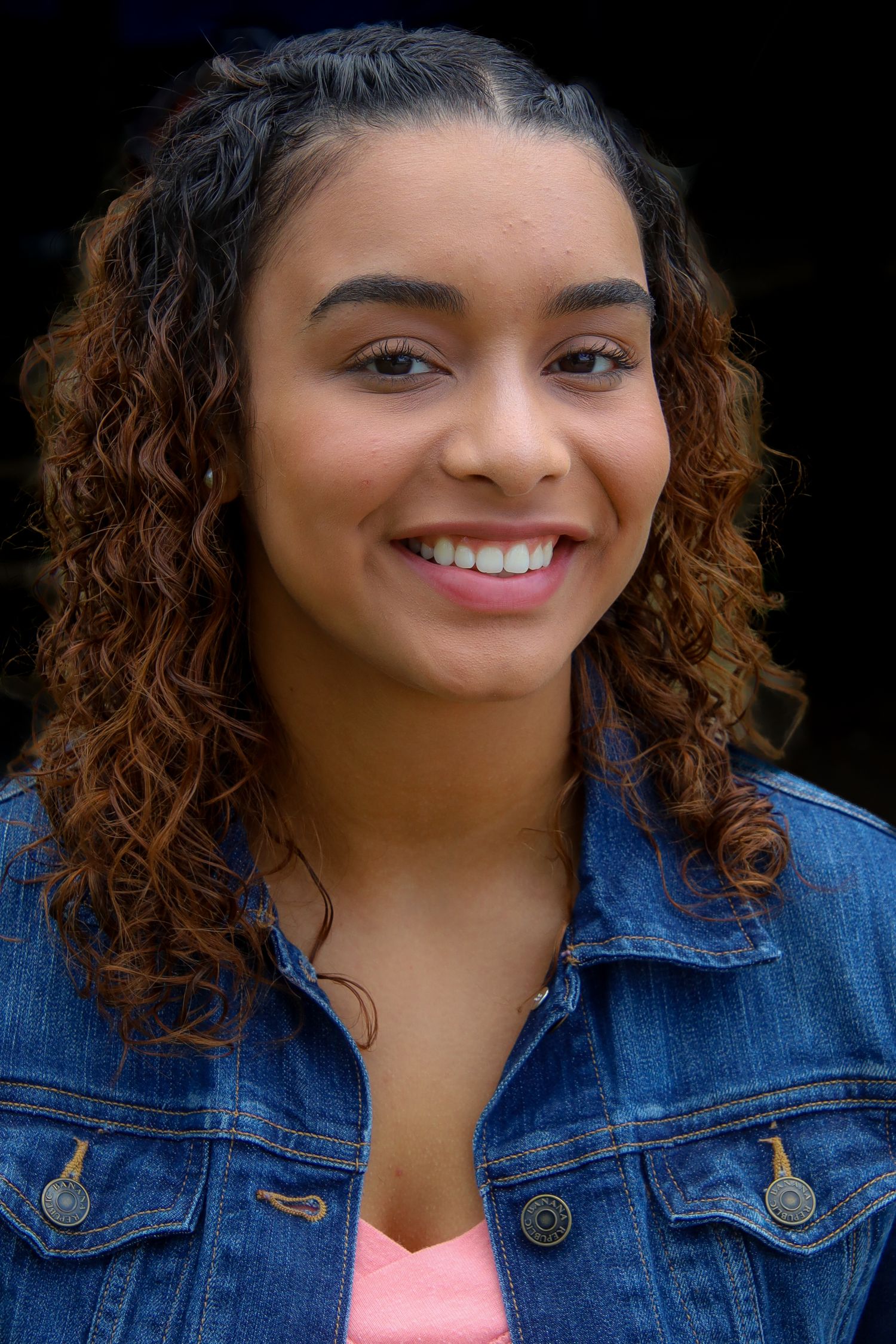 A series of headshots showing someone with curly brown hair and a denim jacket smiling at the camera.