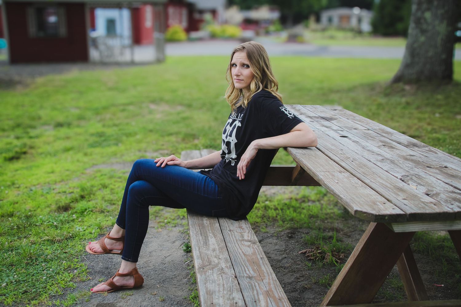 A series of candid photos showing someone sitting and relaxing on a wooden picnic bench in a park setting.