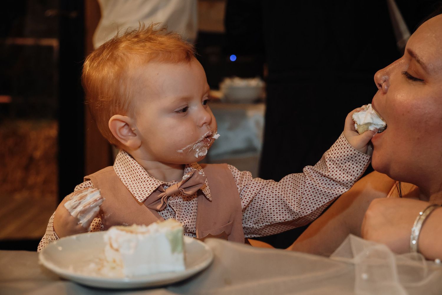 A series of photos showing a small child blowing out birthday candles on a cake during a celebration.
