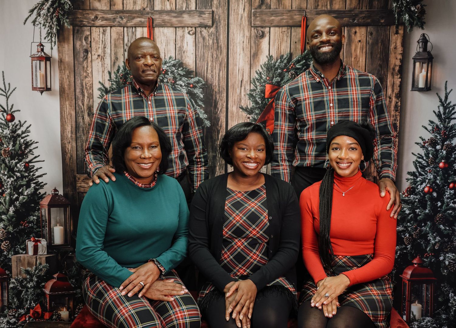 A festive holiday photo collage with people wearing plaid and solid colored outfits against a rustic wooden backdrop.