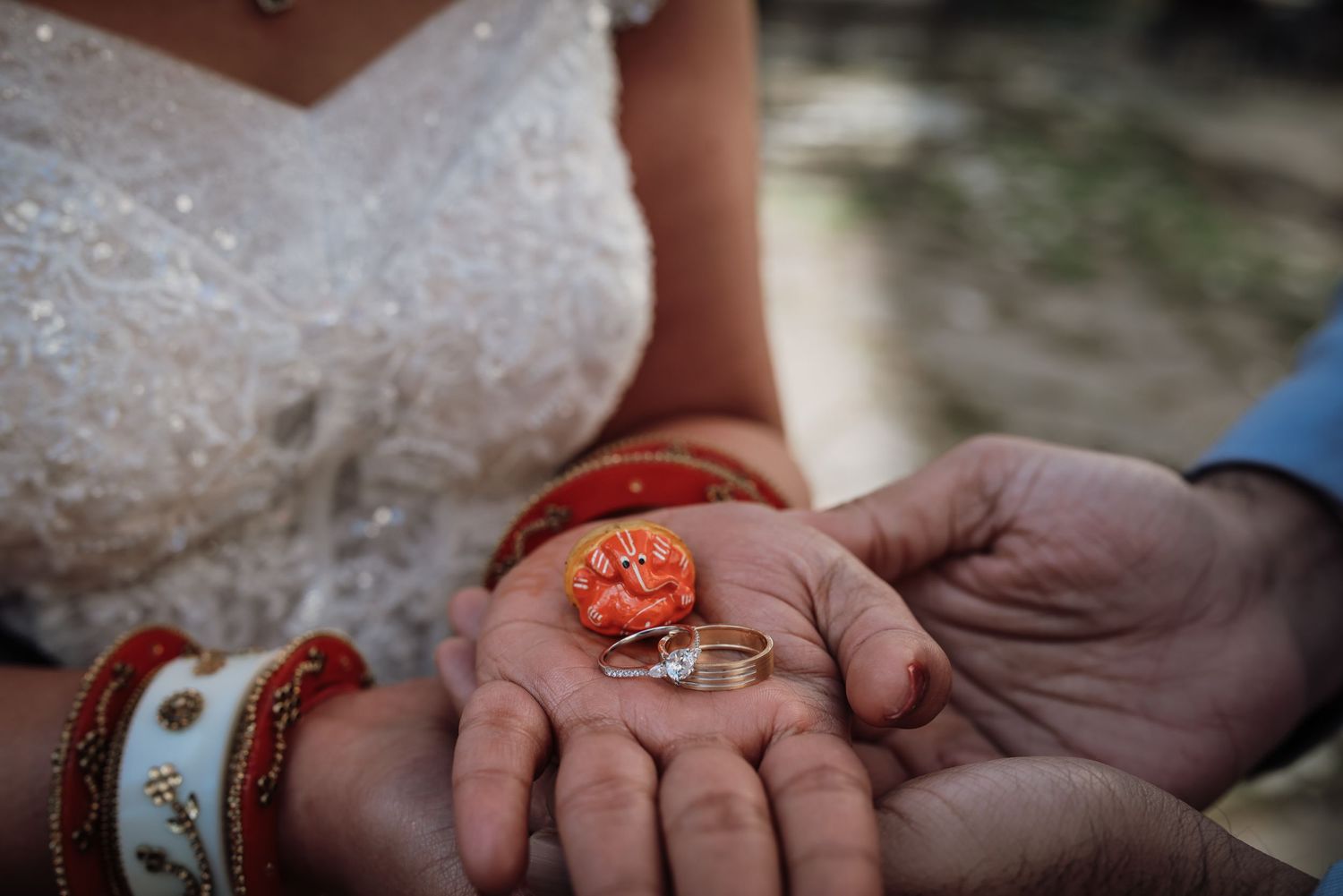 Close-up detail shots of hands showing wedding rings and jewelry during a ceremony.