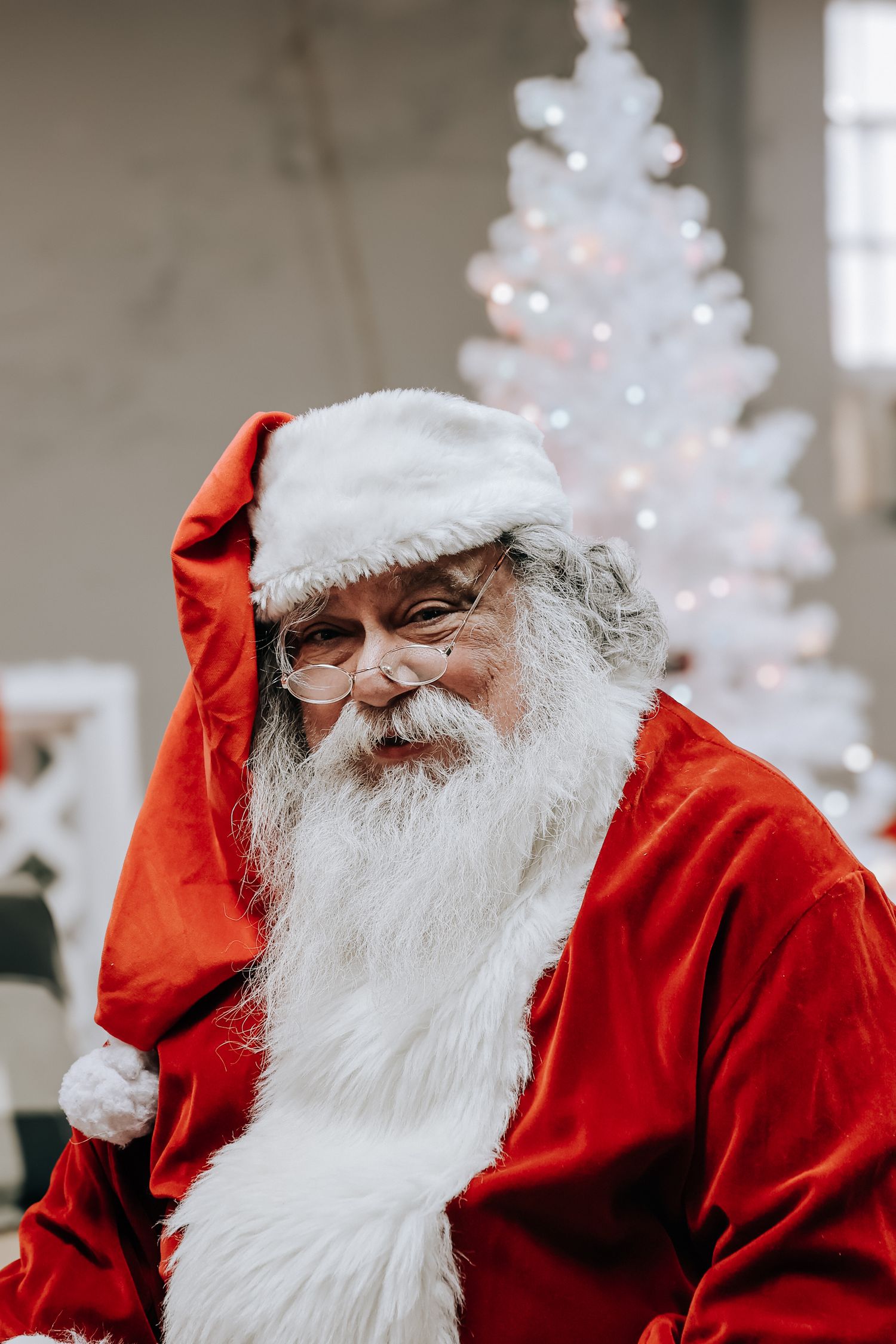 A traditional Santa Claus figure in red suit and white beard shown in four similar poses against a light background.