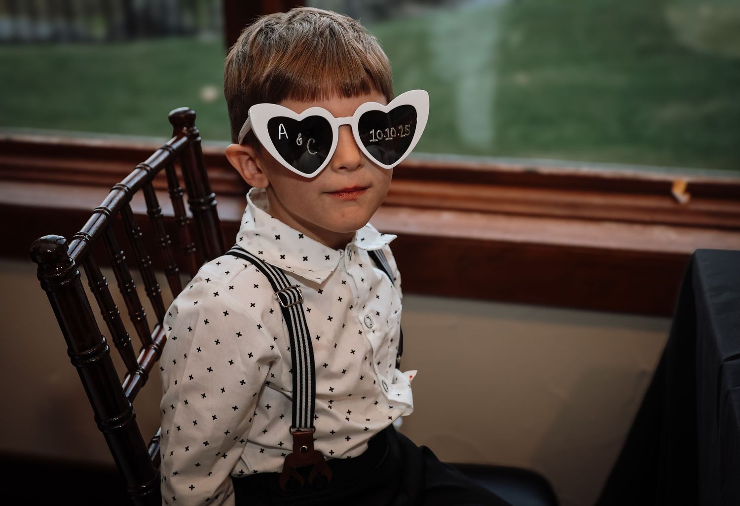 A series of photos showing someone in a polka dot blouse and heart-shaped sunglasses sitting in different poses.