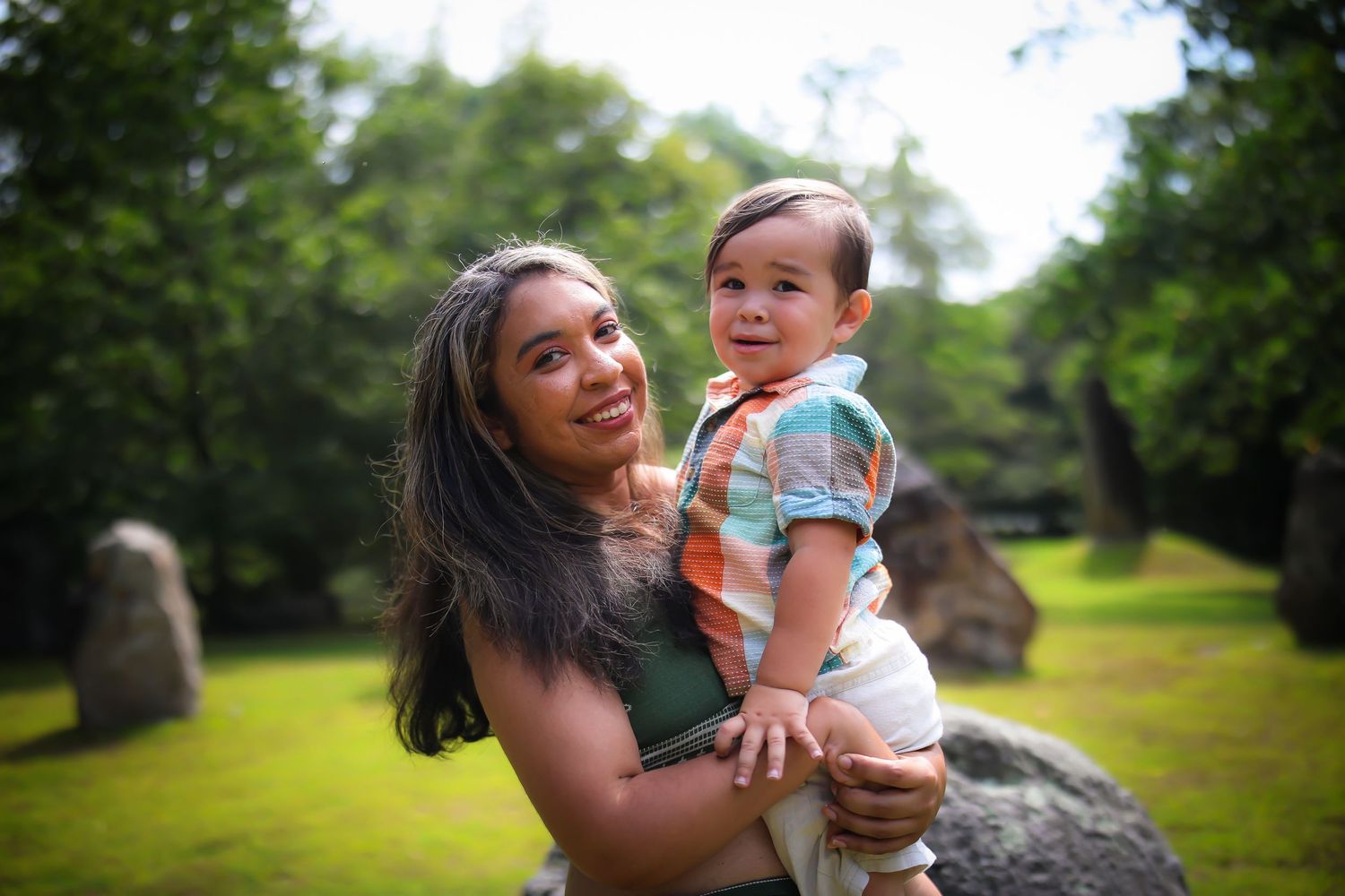 A series of candid outdoor photos showing joyful moments between parent and child in a sunny park setting.