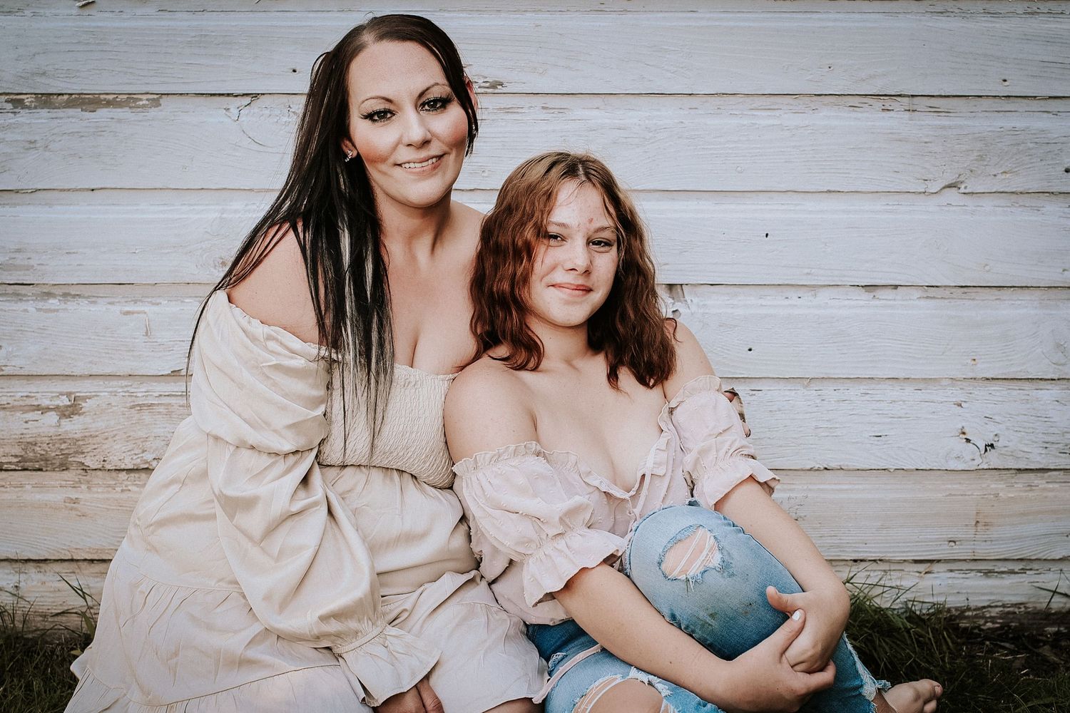 A series of warm-toned family portraits against a rustic wooden wall backdrop in matching neutral outfits.