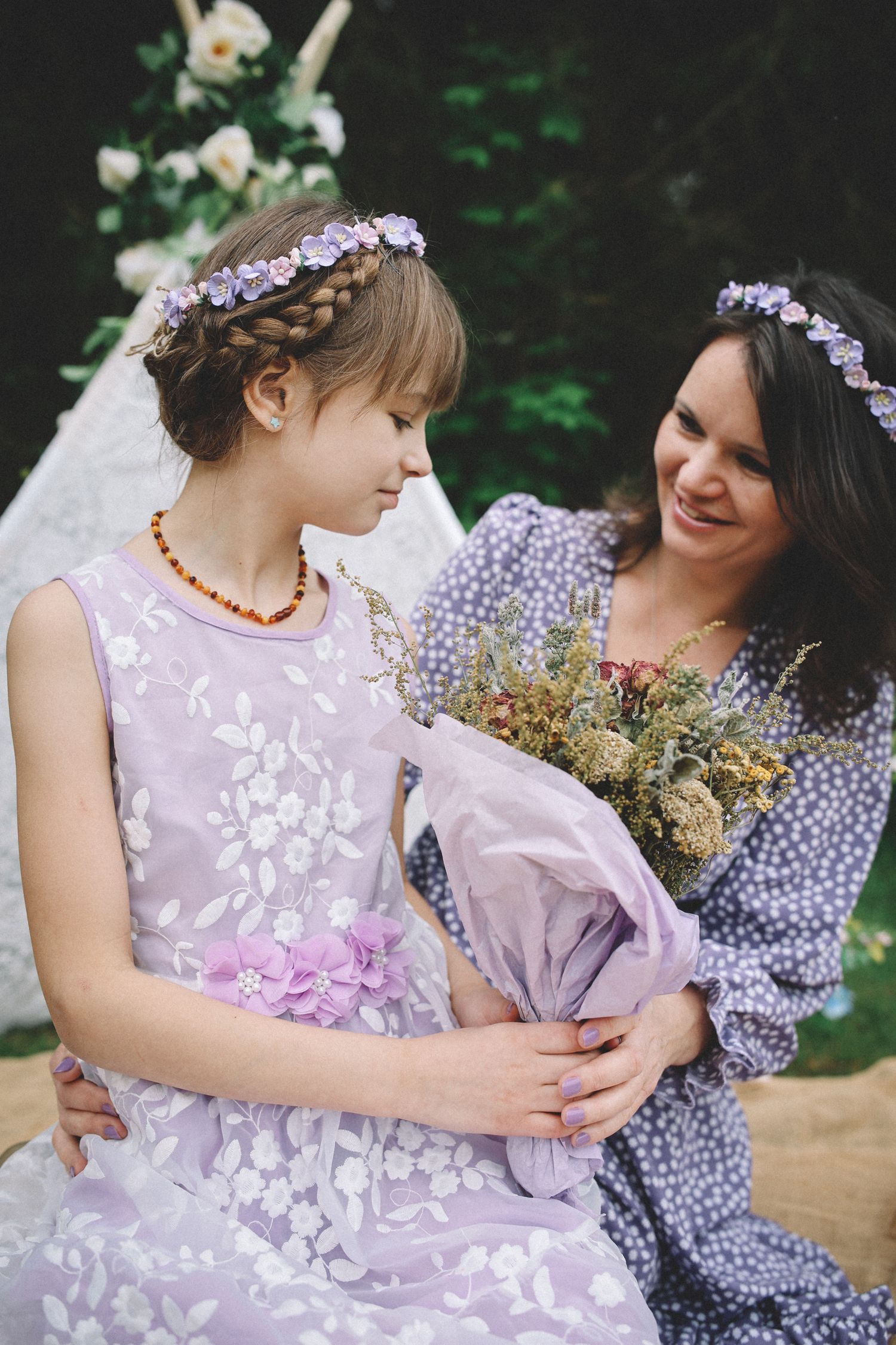 A heartwarming series of photos showing tender moments between two people in purple dresses with floral details.